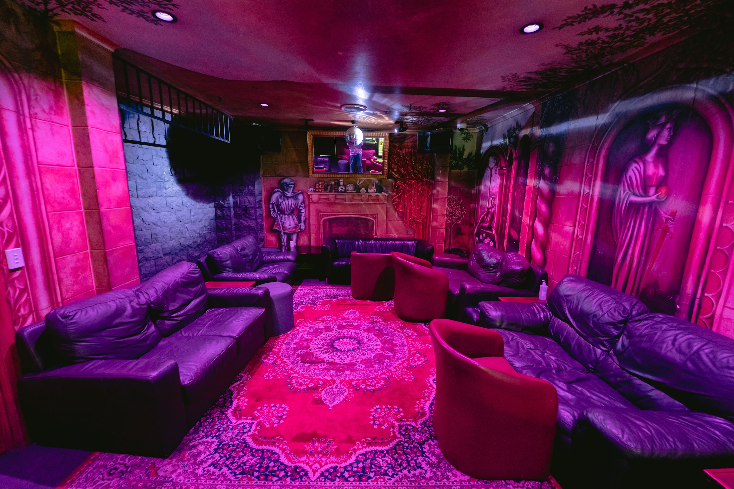 Private lounge with sofas around a dance area at The Men's Gallery Melbourne strip club