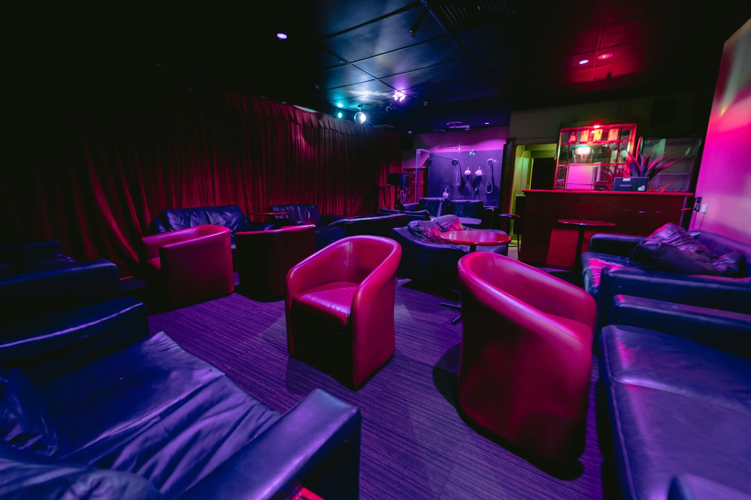 Cozy purple lounge seating area inside The Men's Gallery Melbourne strip club