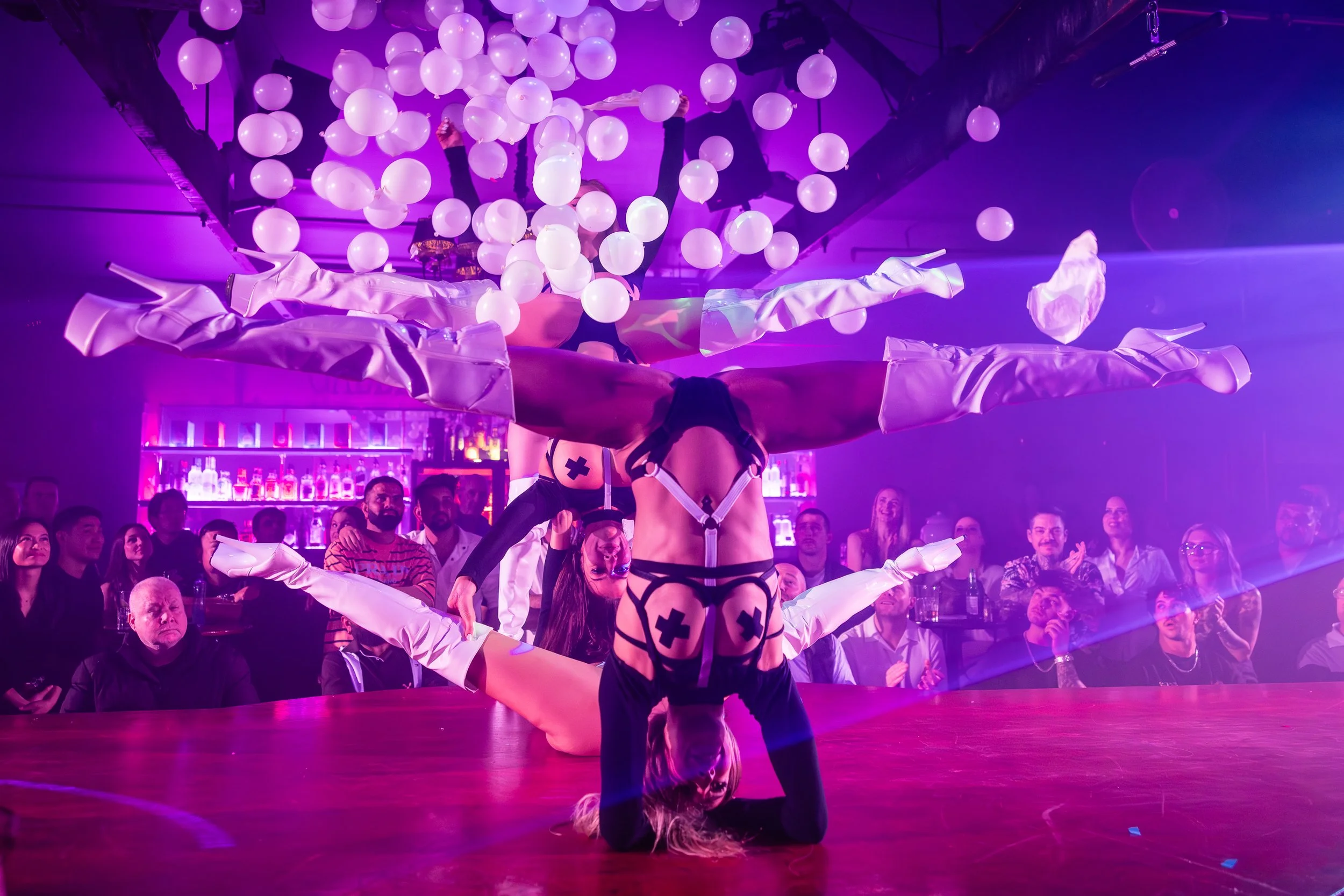 Acrobatic aerial stage performer in costume during a feature show at The Men's Gallery Melbourne strip club