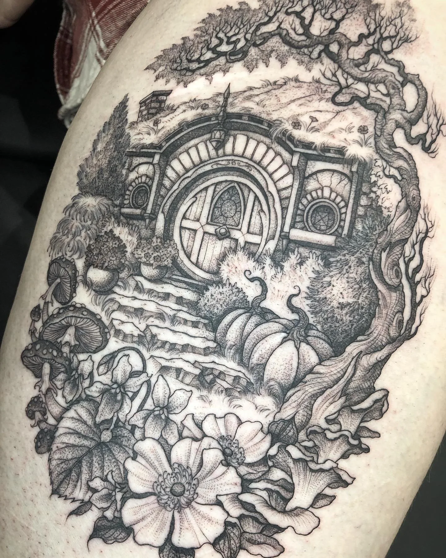 Fine line black and grey tattoo of Hobbiton from Lord of the rings by Eddy Lou