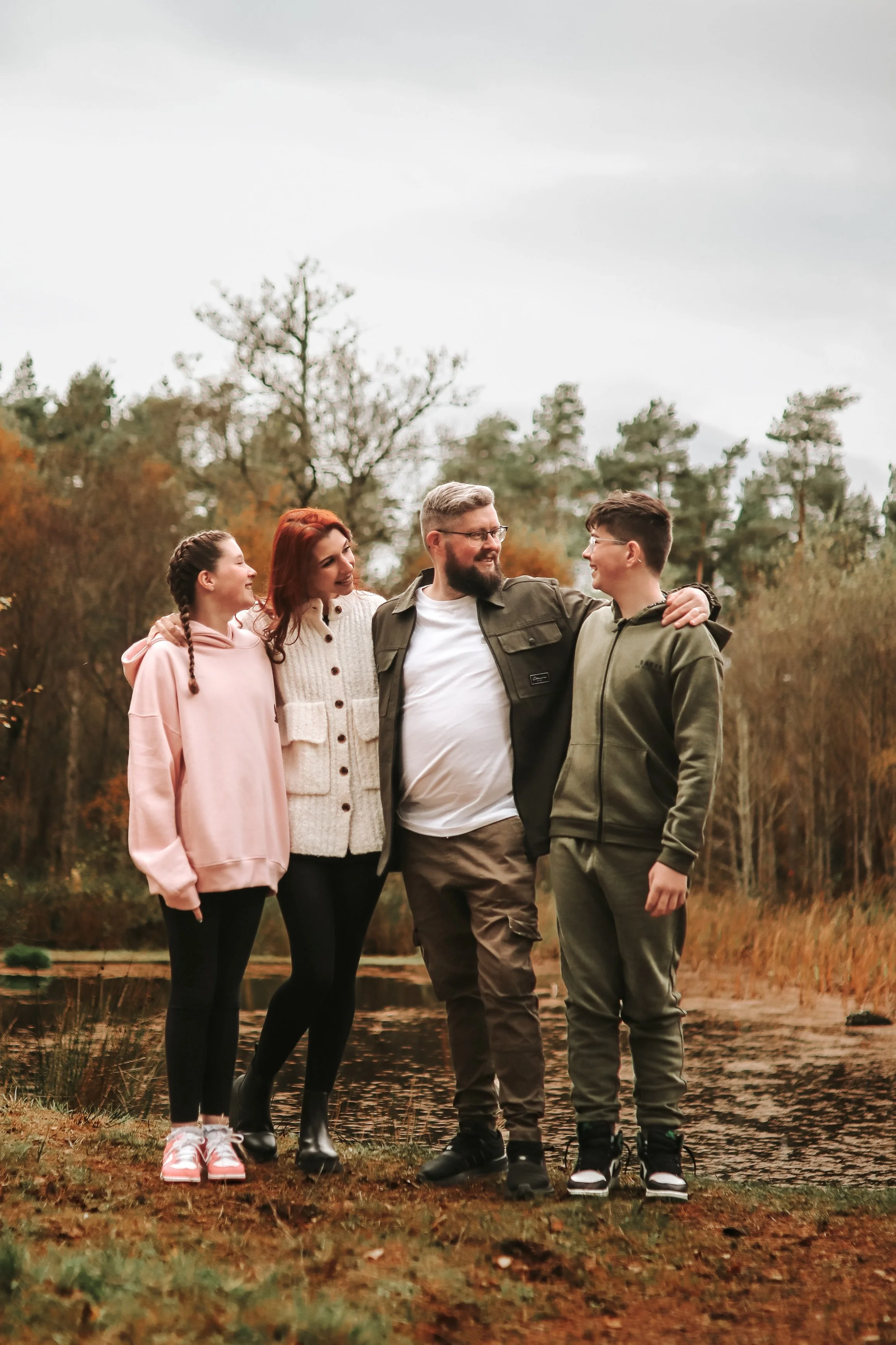 Family photography Scottish Highlands parents with teenage children walking together outdoors in autumn