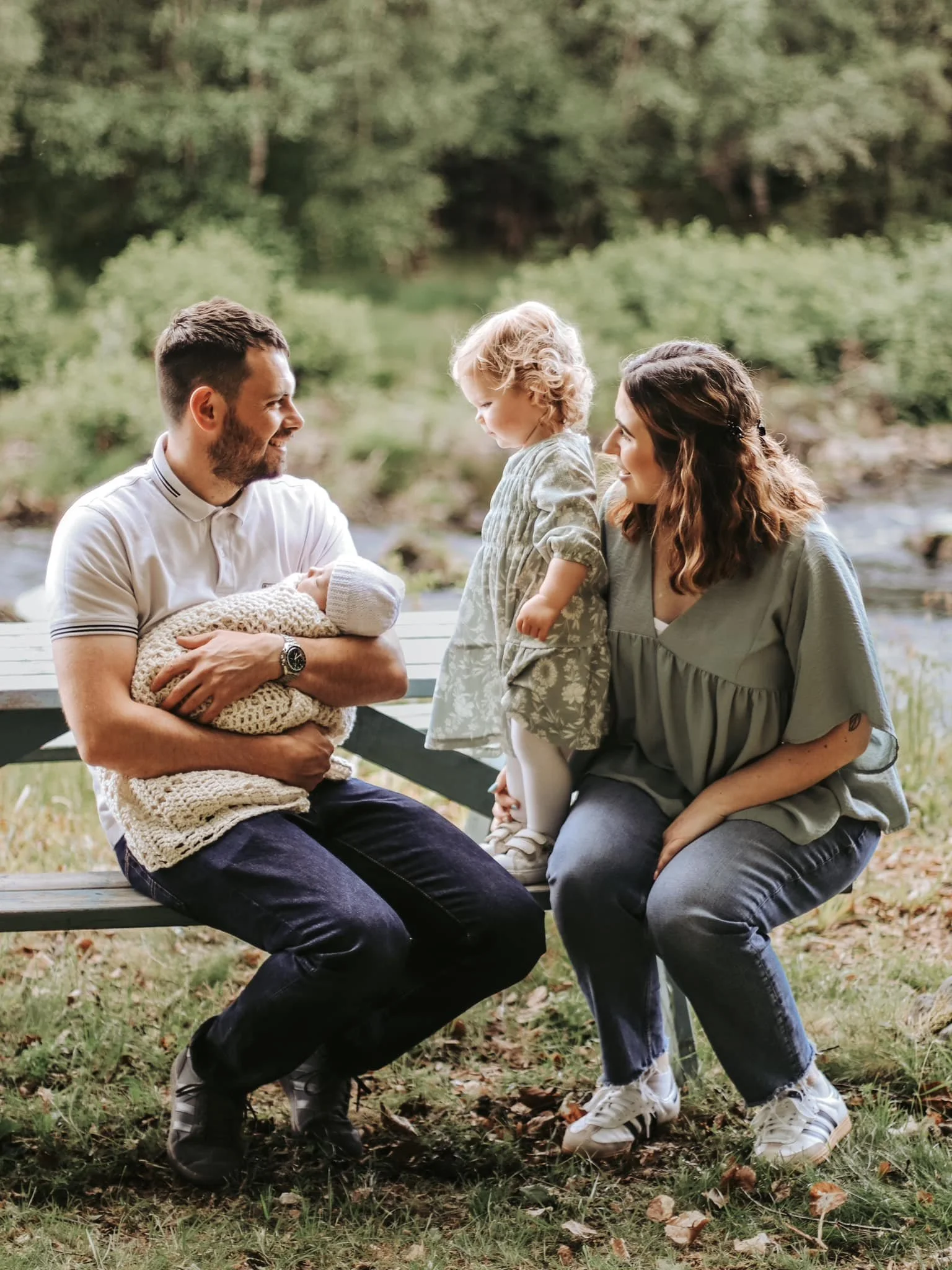 Family and newborn photography Scottish Highlands parents with baby and toddler outdoors in natural light
