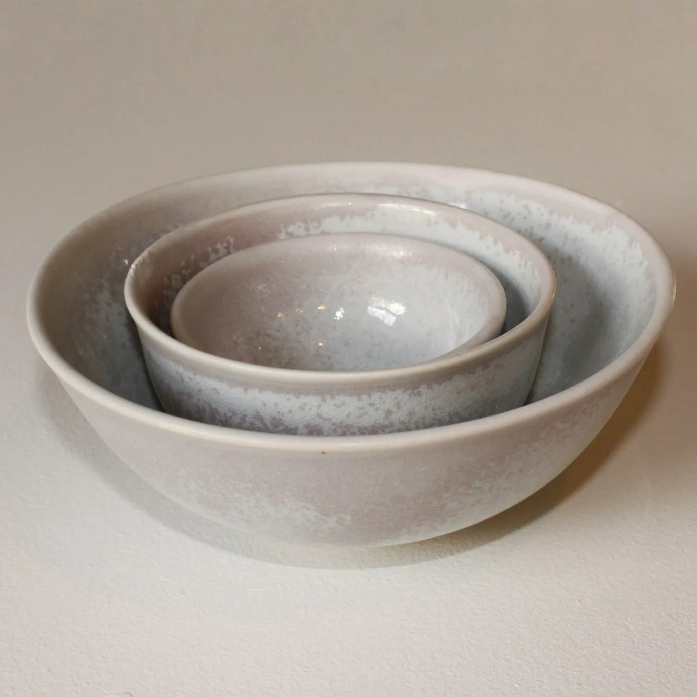Set of three nested ceramic bowls with a crystalline celadon glaze