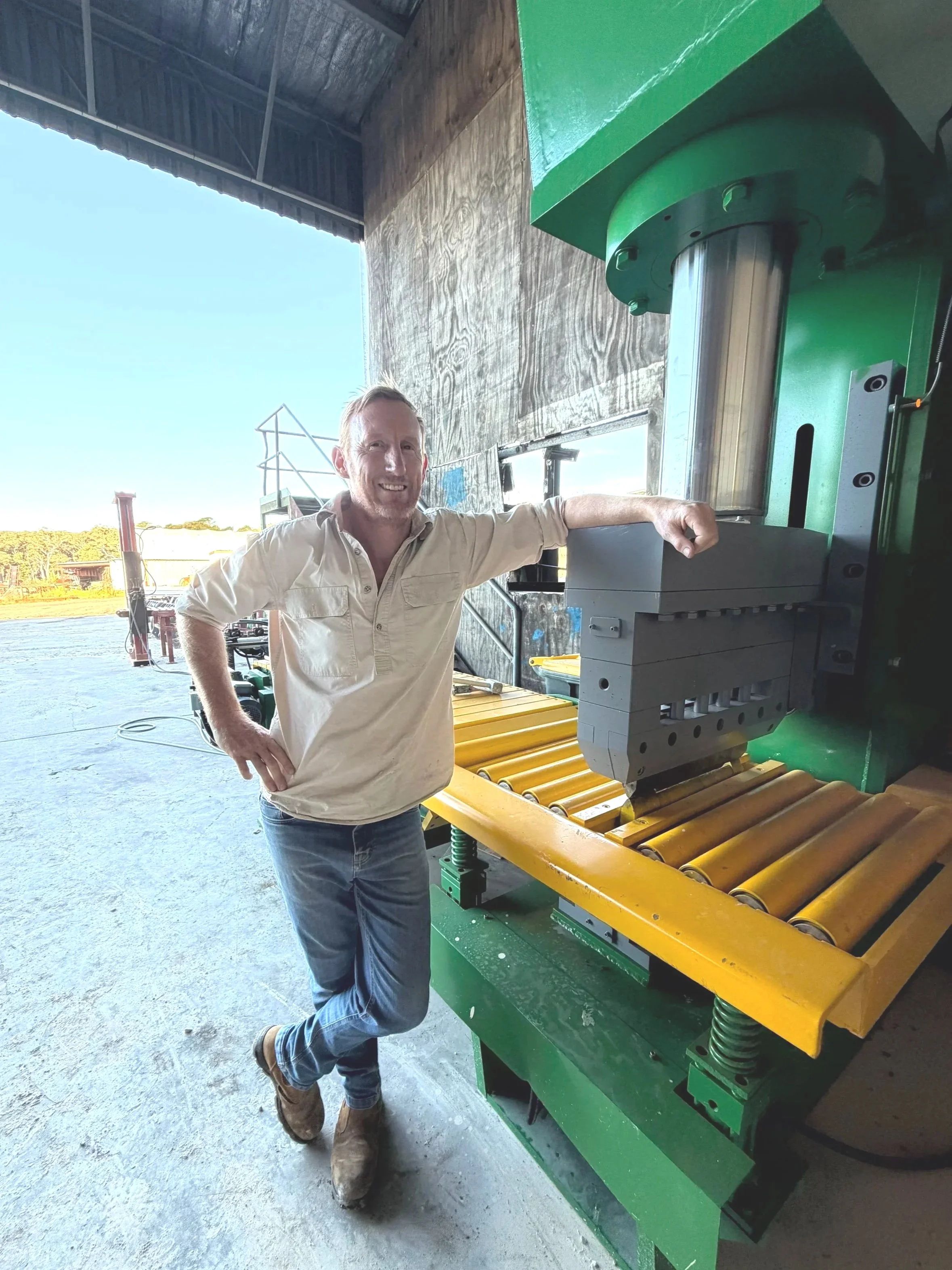 JVS Stone Supplies founder Jason Simpson in the yard with the hydraulic stone splitter used to process Australian stone.