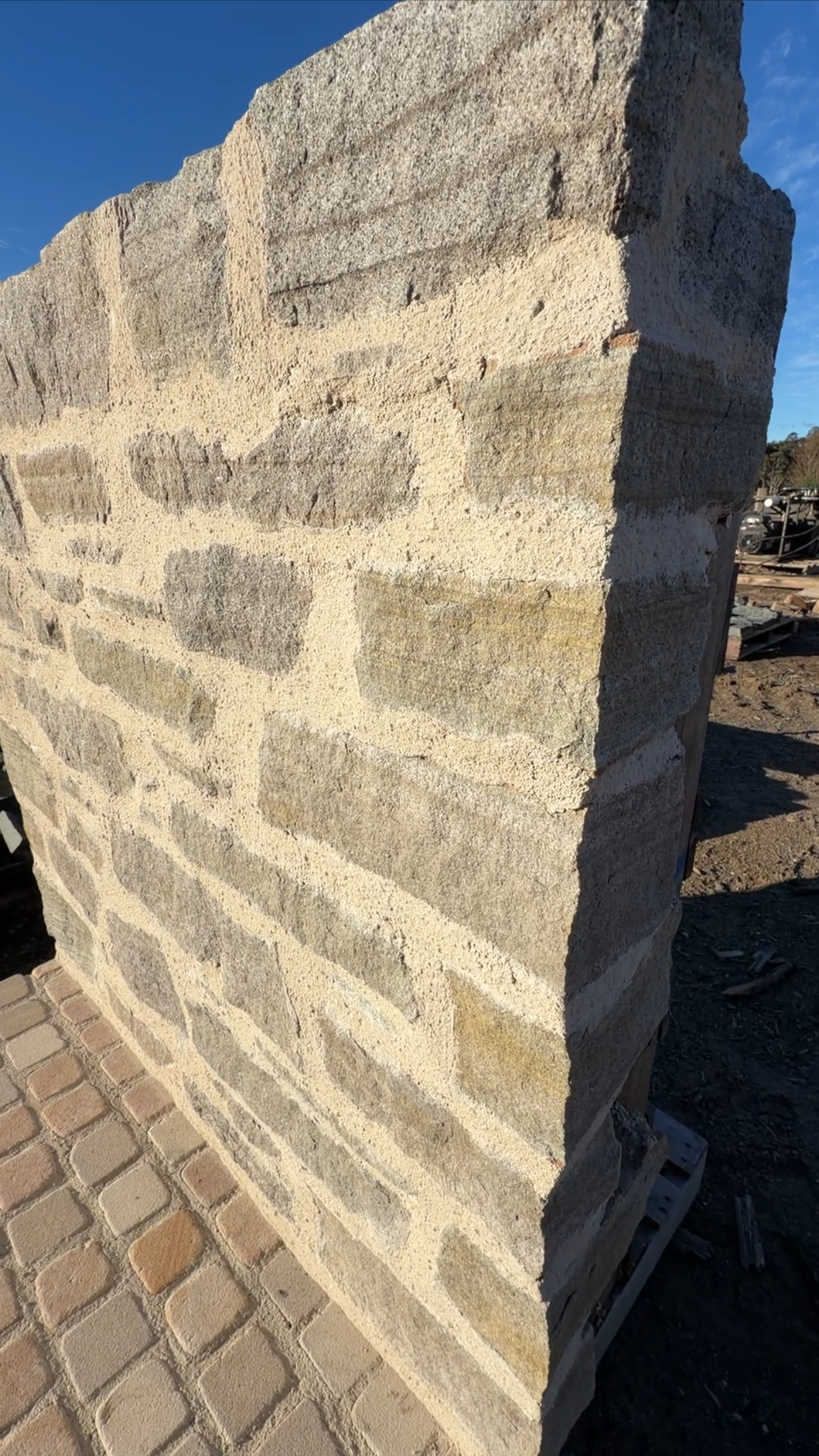 Byron Bay Sandstone wall showing natural textured Australian sandstone laid in drystone style with irregular pieces and grey coastal tones.