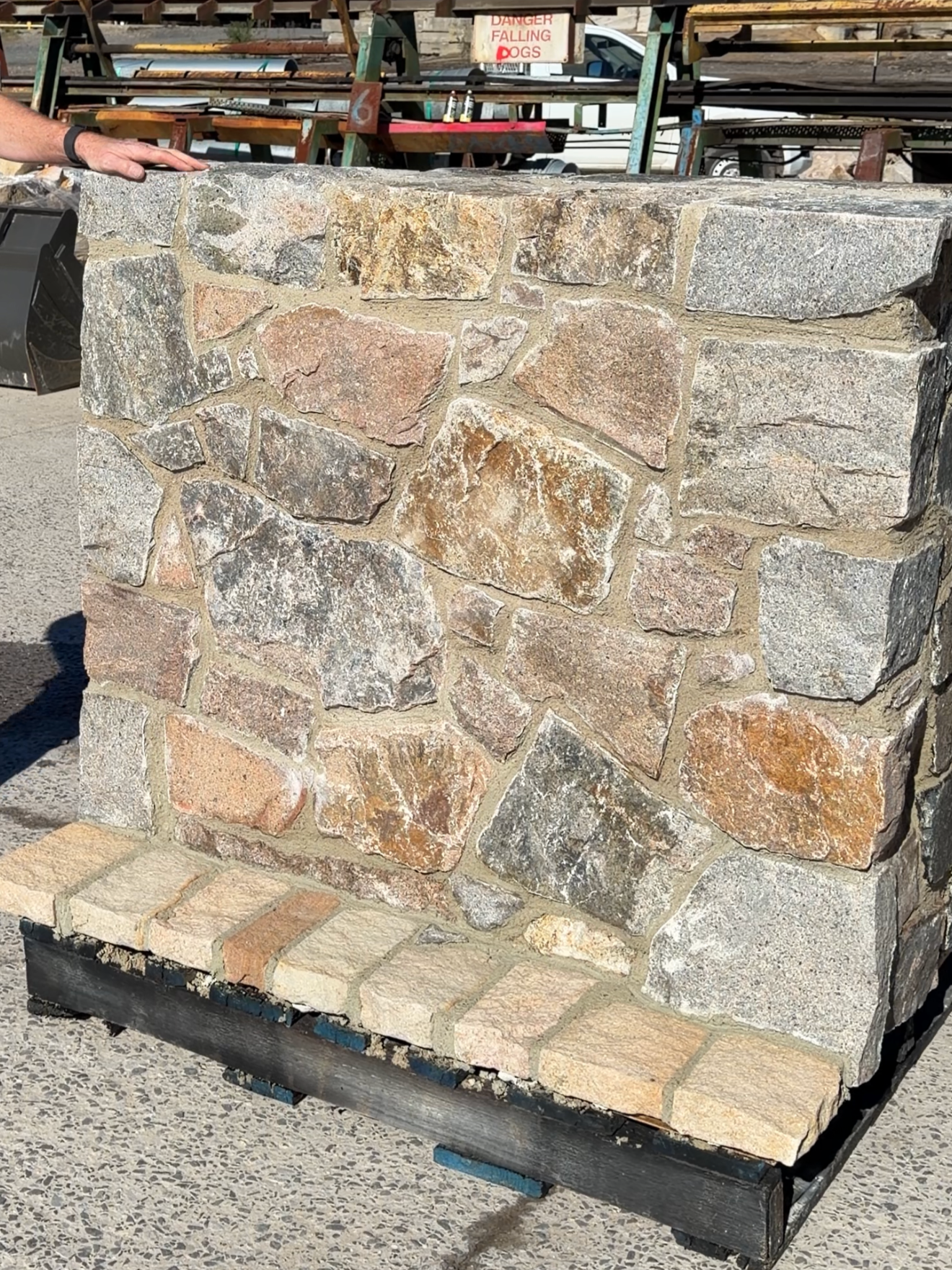 Natural Albury Granite walling stone with mixed grey, ochre and rust colours in a mortared sample wall.