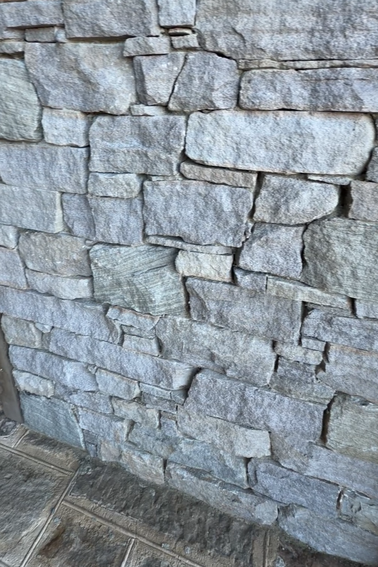 Byron Bay Sandstone wall showing natural textured Australian sandstone laid in drystone style with irregular pieces and grey coastal tones.