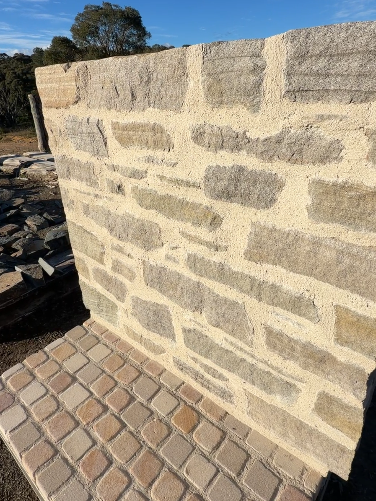 Byron Bay Sandstone wall showing natural textured Australian sandstone laid in drystone style with irregular pieces and grey coastal tones.