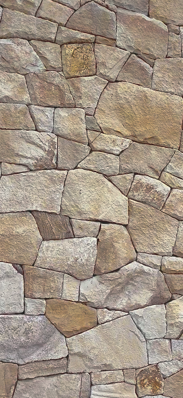 Close-up of a stone wall with irregularly shaped stones fitted together.