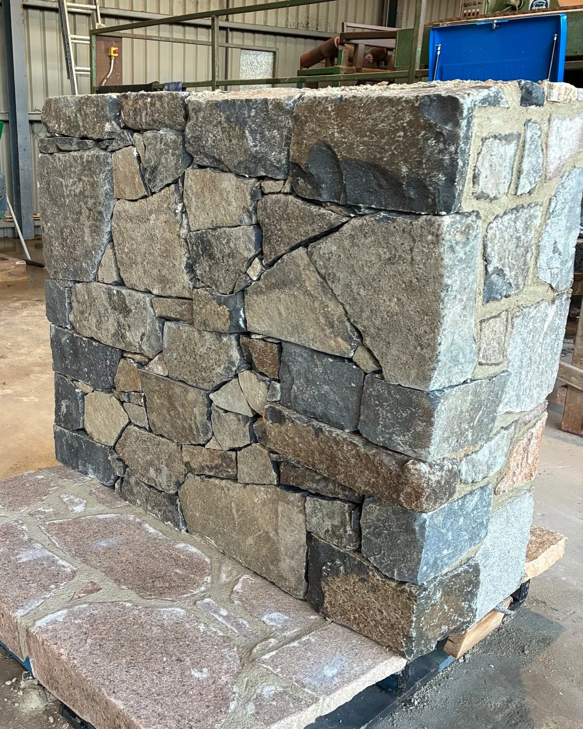 Australian Nimmitabel Bluestone laid as walling stone with a textured split face and cool grey-blue colour variation.