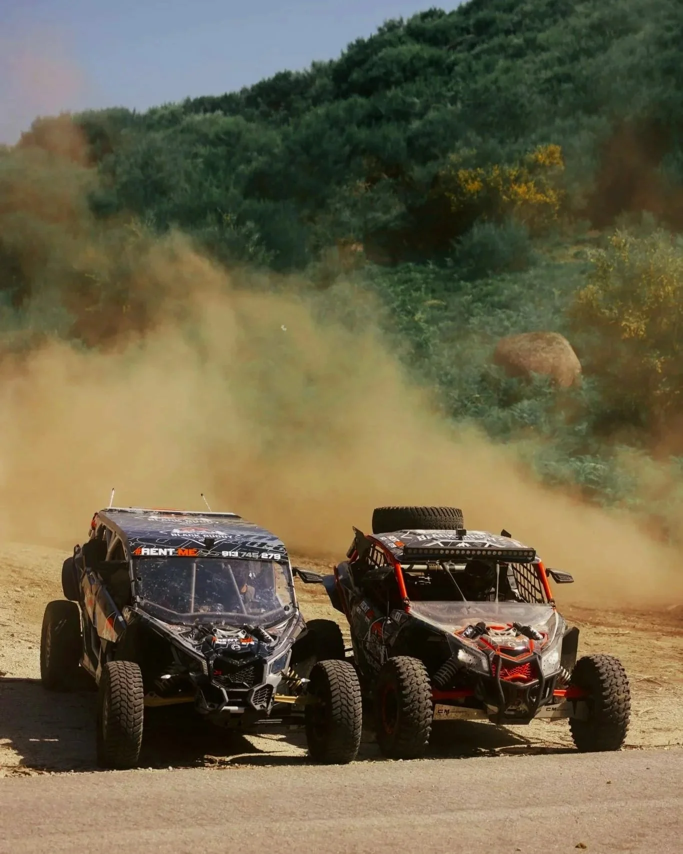 Dois buggies Can-Am Maverick X3 da Black Buggy Tours em passeio off-road nos trilhos de Braga, Norte de Portugal, rodeados por um ambiente natural de arborizado com árvores verdes.