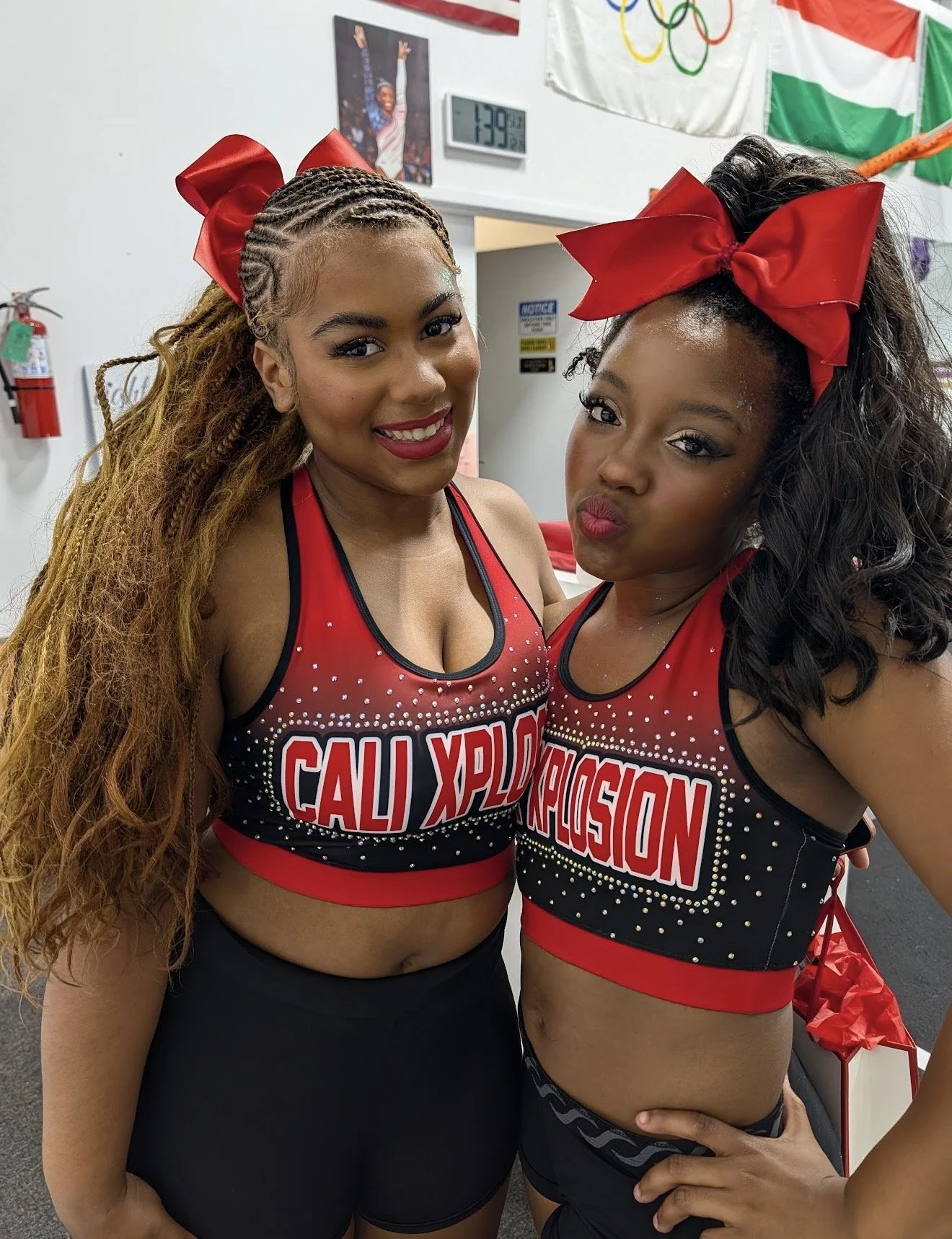 Two cheerleaders in red and black uniforms with