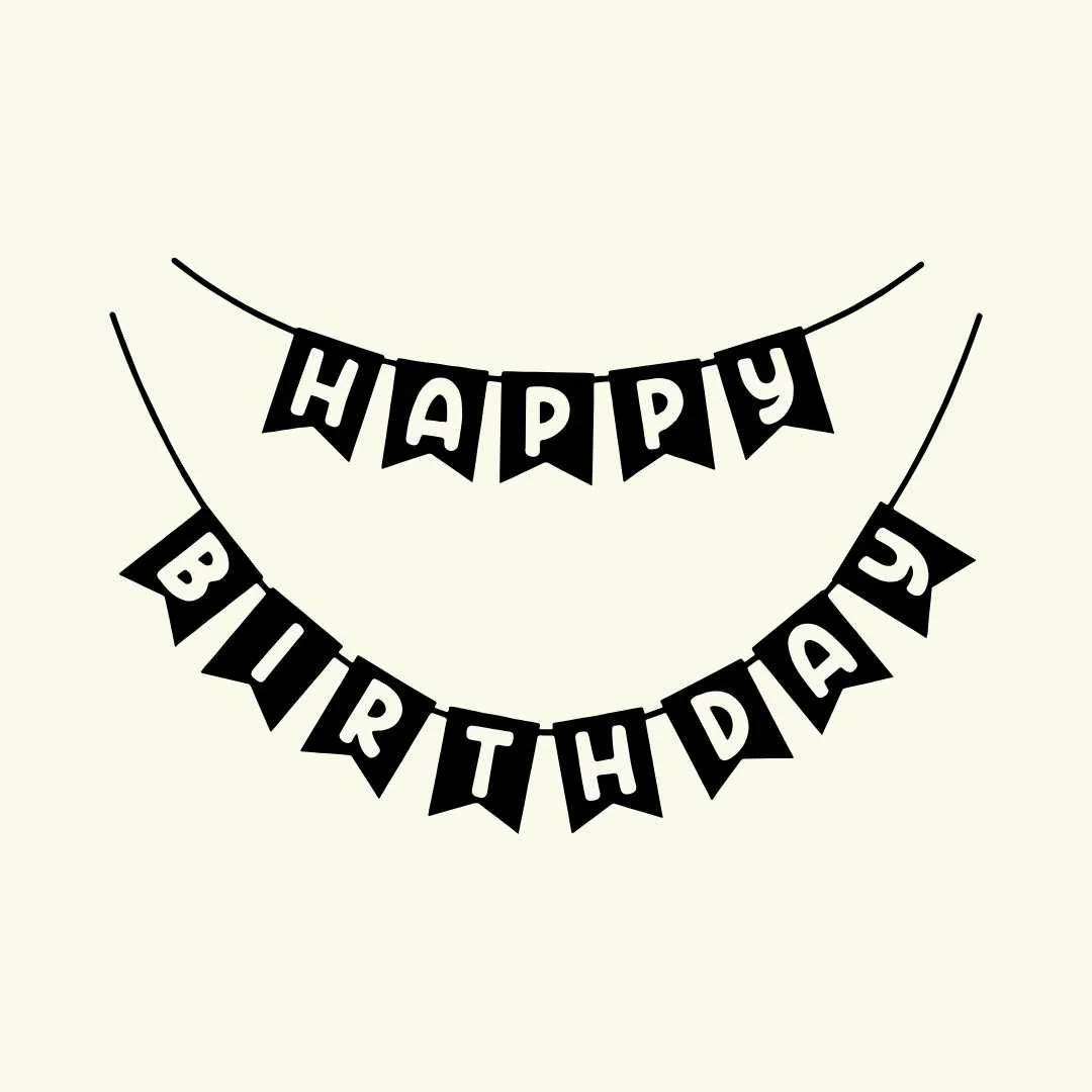 Black and white paper banners that say "HAPPY BIRTHDAY" hanging on strings.