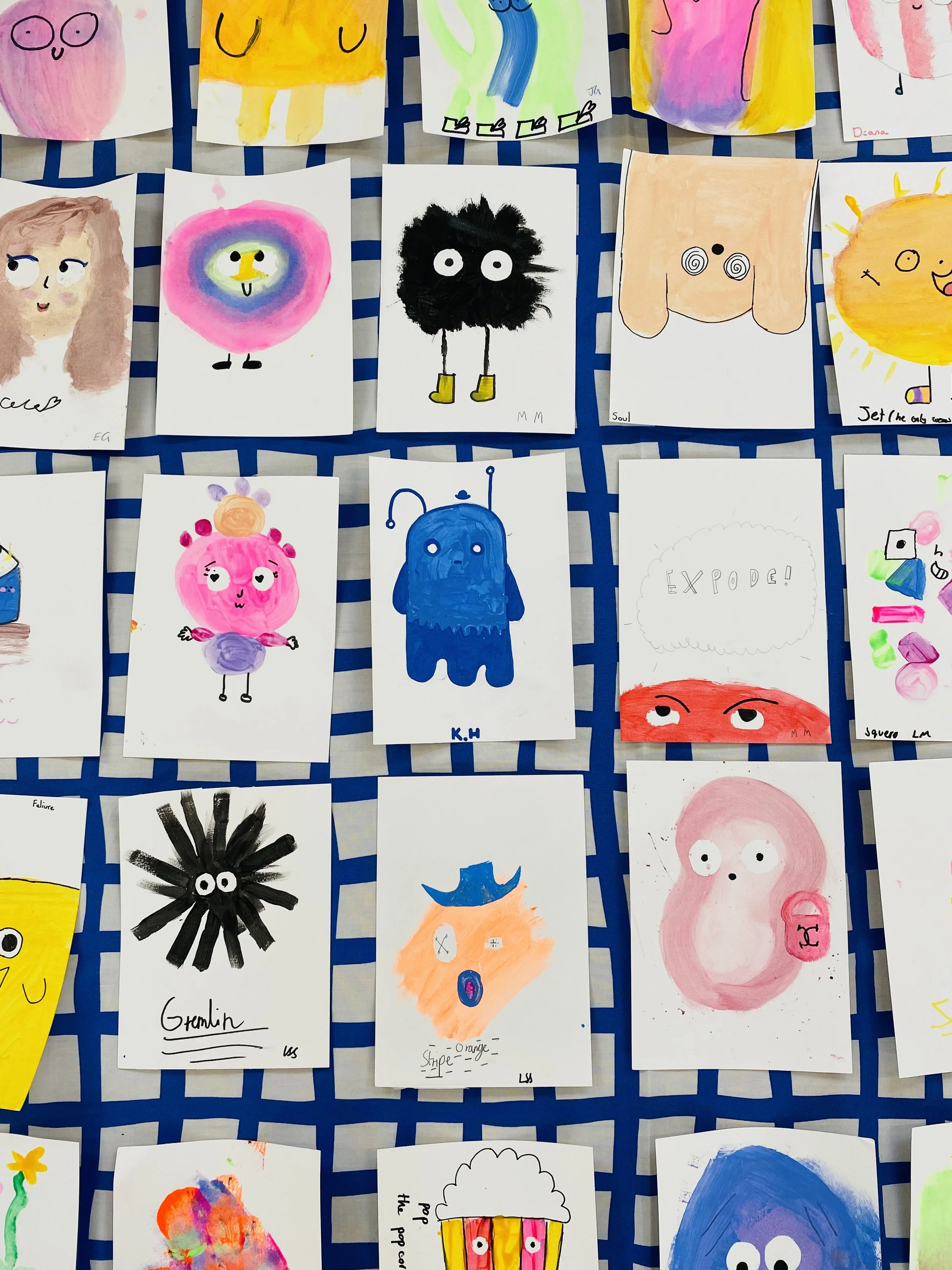 Collection of colorful children's drawings of various characters and objects, displayed on a blue grid background.