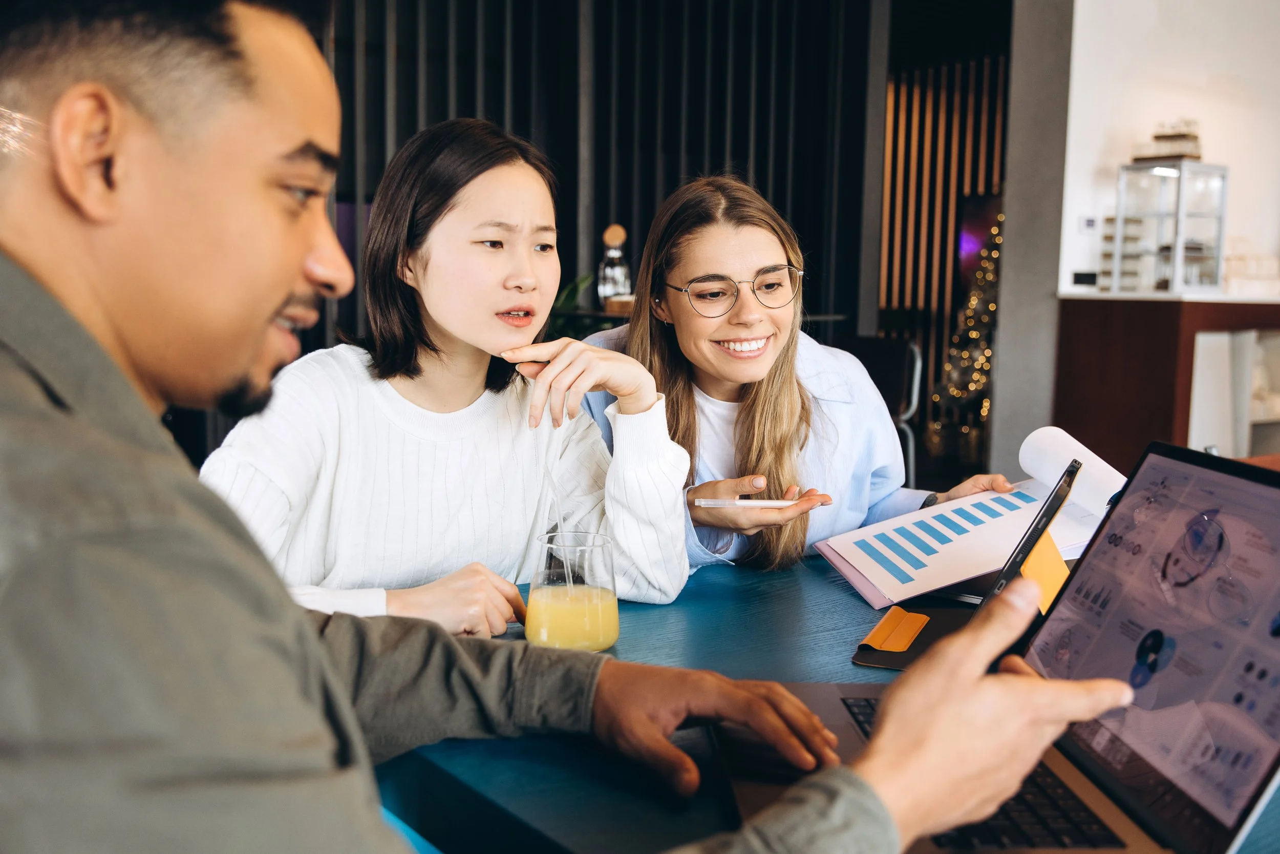 Marketing team reviewing charts and campaign performance on a laptop