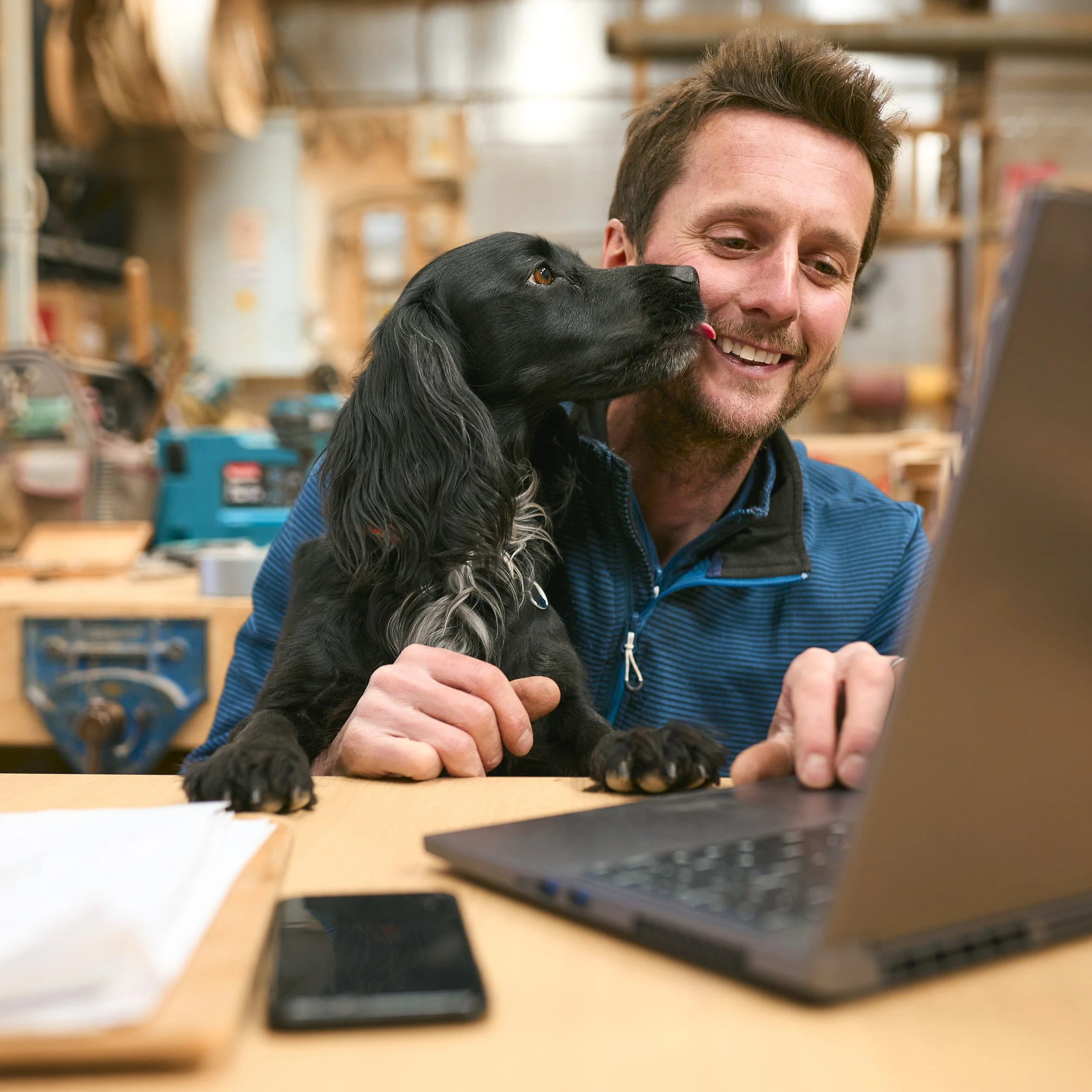 carpenter-with-pet-spaniel-working-in-woodwork-wor-2026-03-10-03-14-01-utc.jpg