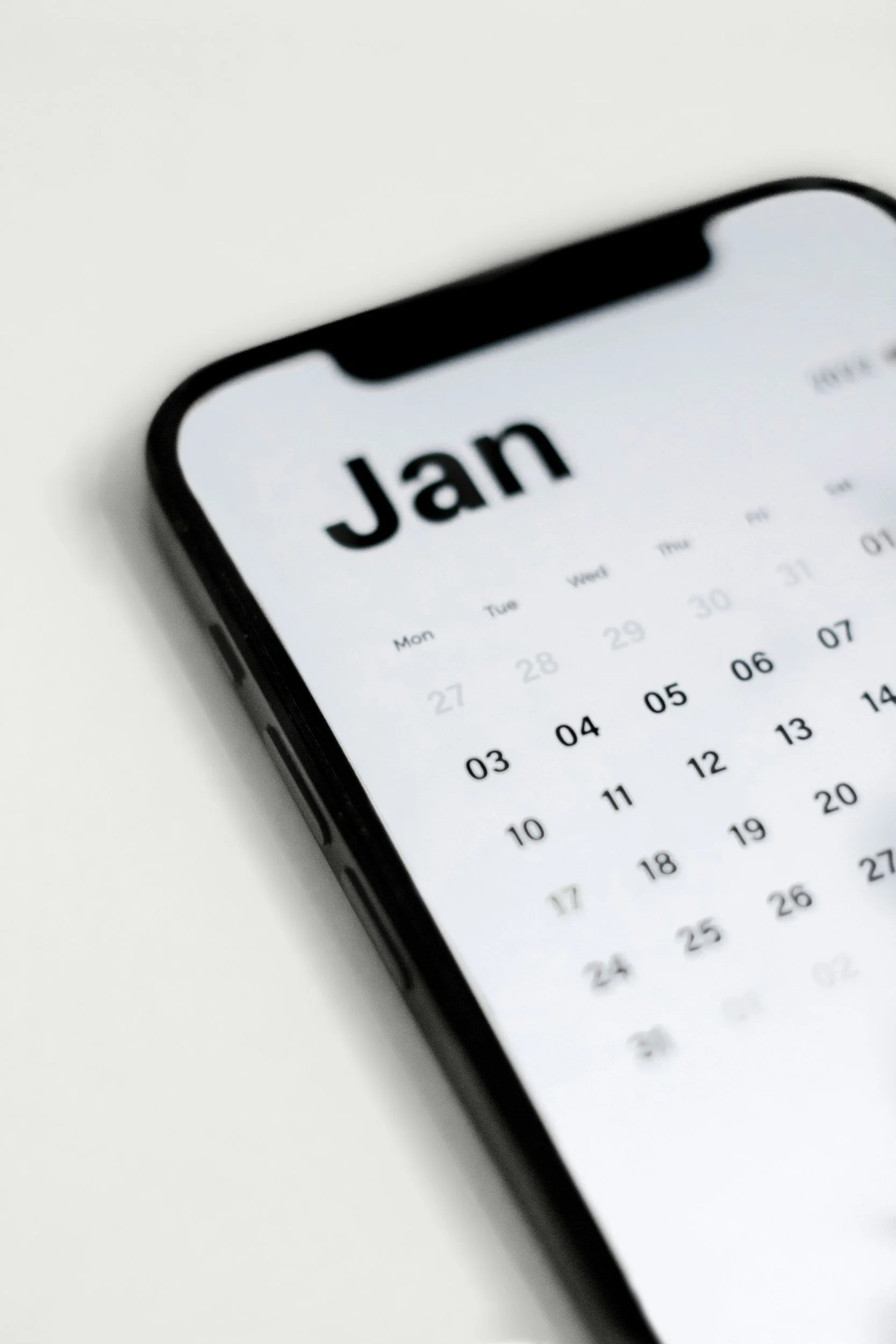 A smartphone displaying a calendar app with the month 'Jan' visible.