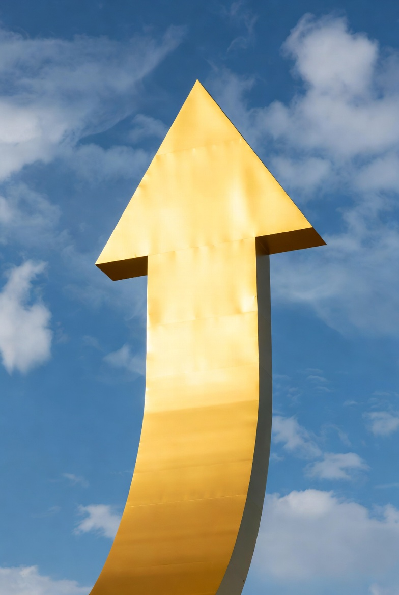 A large golden arrow pointing upward against a blue sky with scattered white clouds.