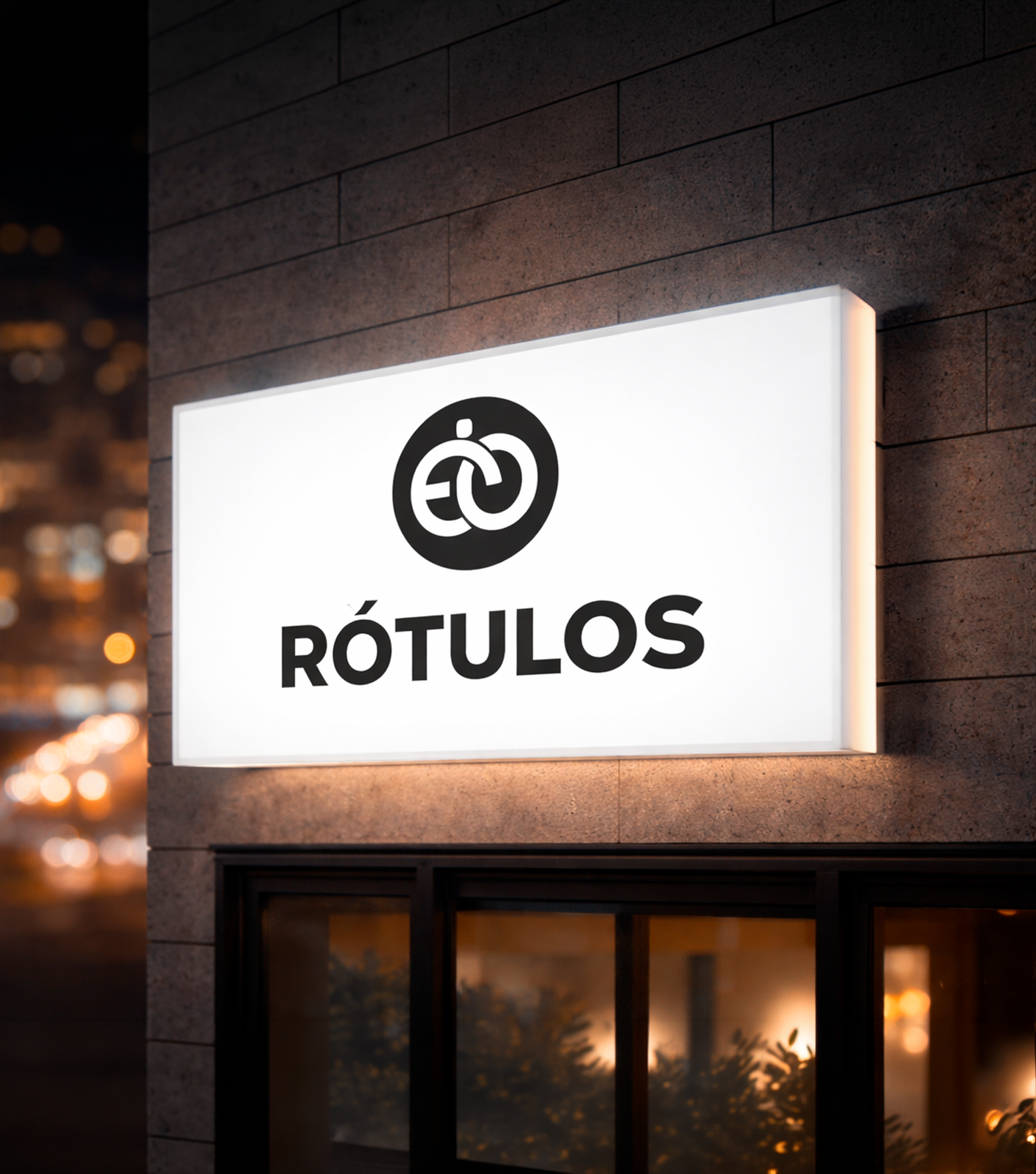 Letrero luminoso con logotipo y texto que dice 'RÓTULOS' en una pared de ladrillos, en la noche.
