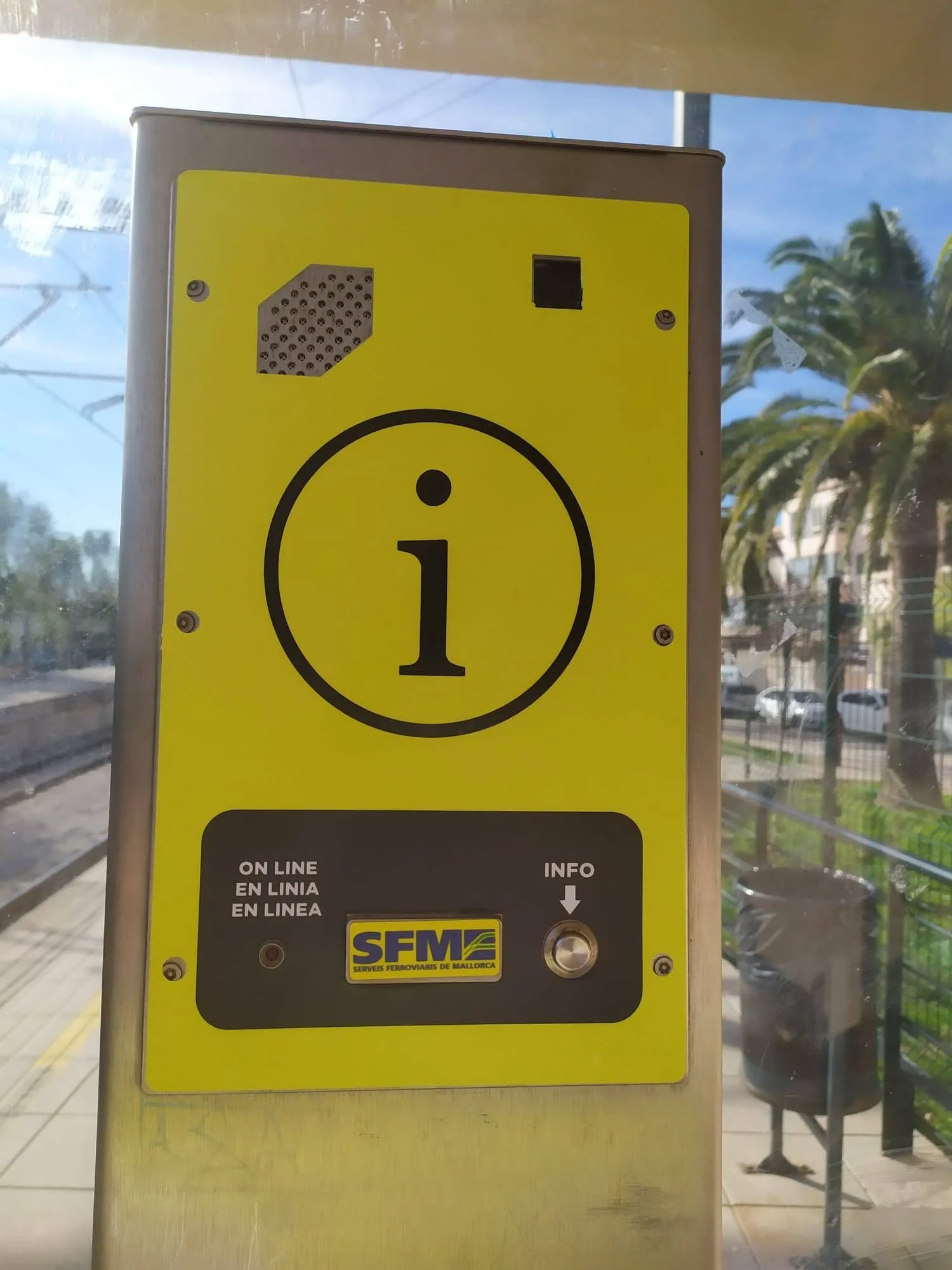 Pantalla informativa en una estación de tren o autobús con logo de SEM en Mallorca, instrucciones para uso en línea y símbolo de información en el centro.