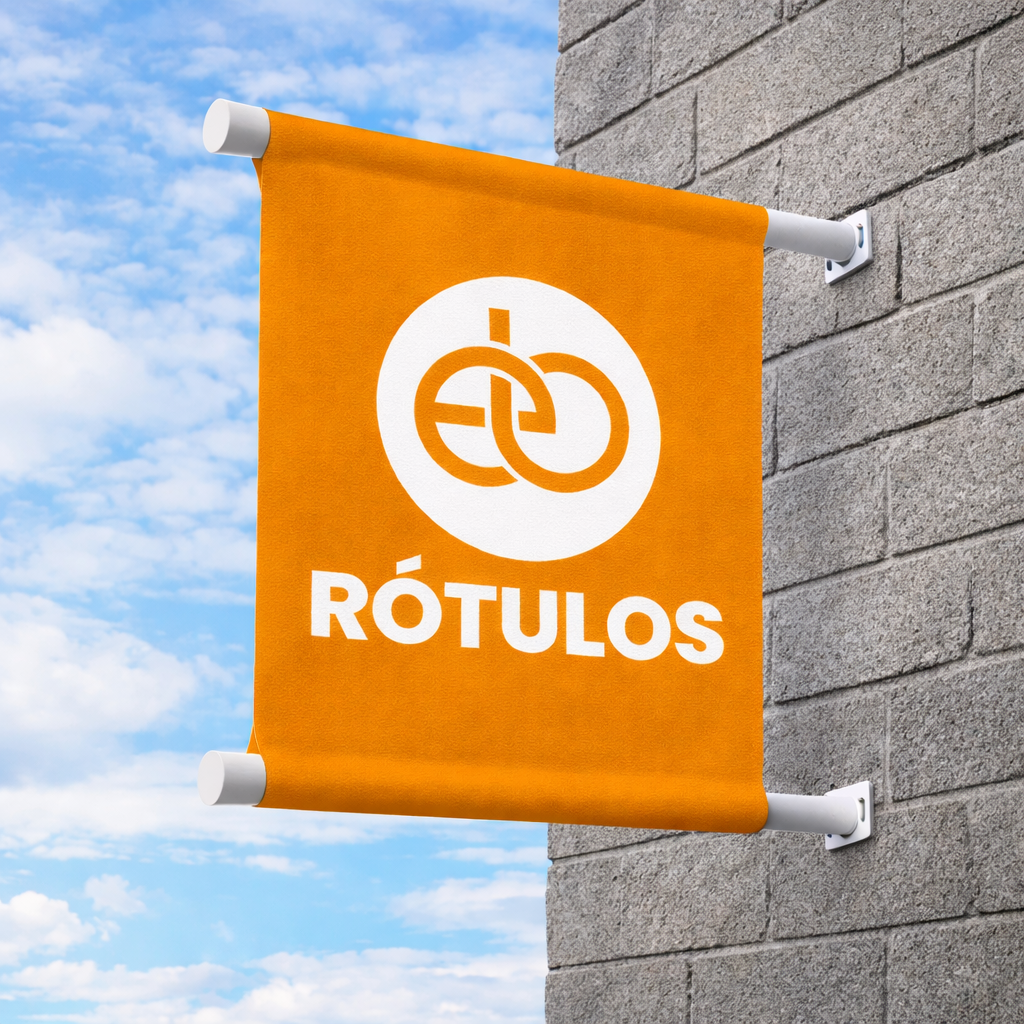 Un cartel naranja colgado en la pared que dice 'RÓTULOS' con un logo circular en blanco.