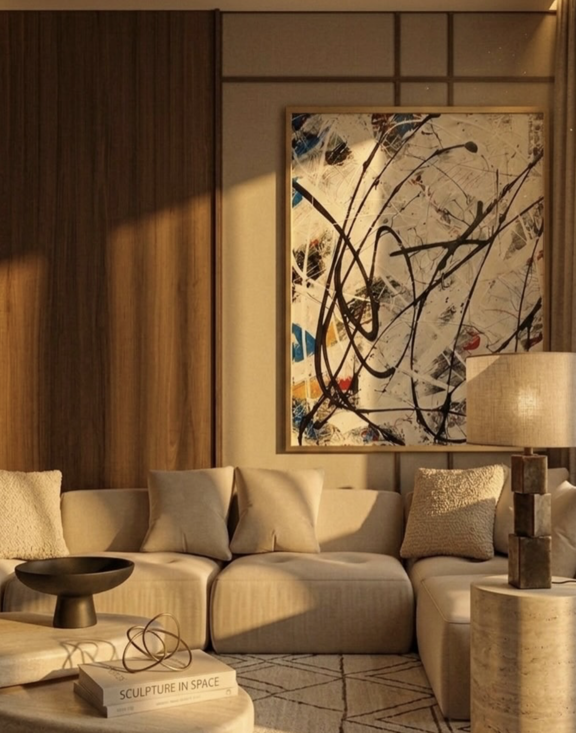 Marina Dubai living room with beige sofa, decorative pillows, modern abstract painting on the wall, wooden paneling, a table with books and art sculpture, and a lamp on a cylindrical table designed by Studio 48 Interiors.