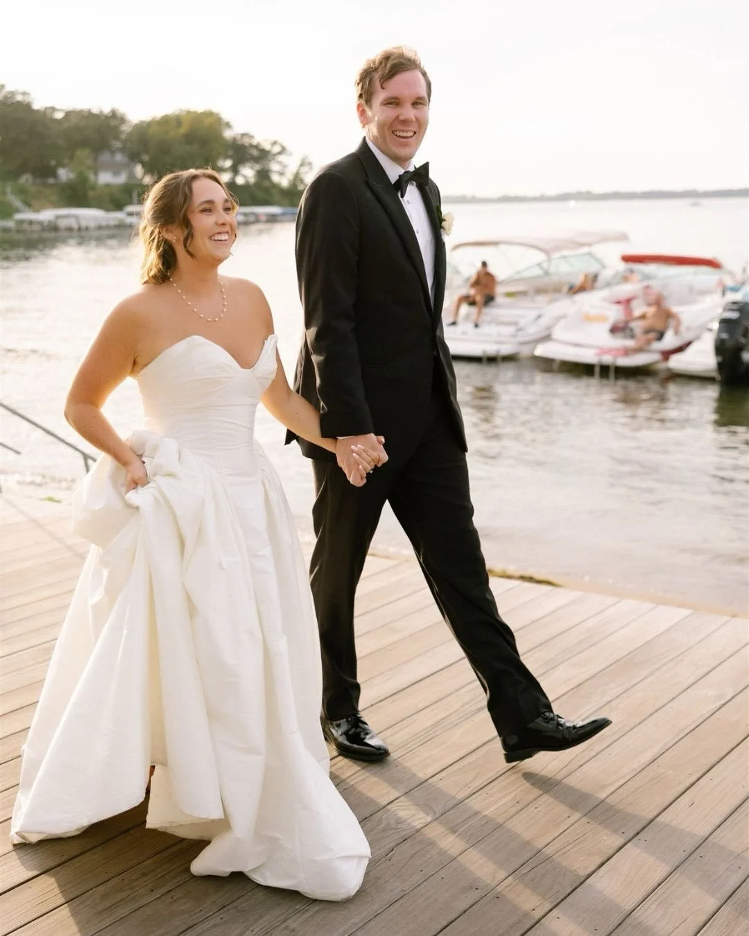 Golden hour, lake breeze, and two people fully in their just-married era. 

Barefoot on the dock, laughing the whole way, dress in hand, nowhere to be except right there together. These are the moments that feel the most like them.

Sunset portraits 