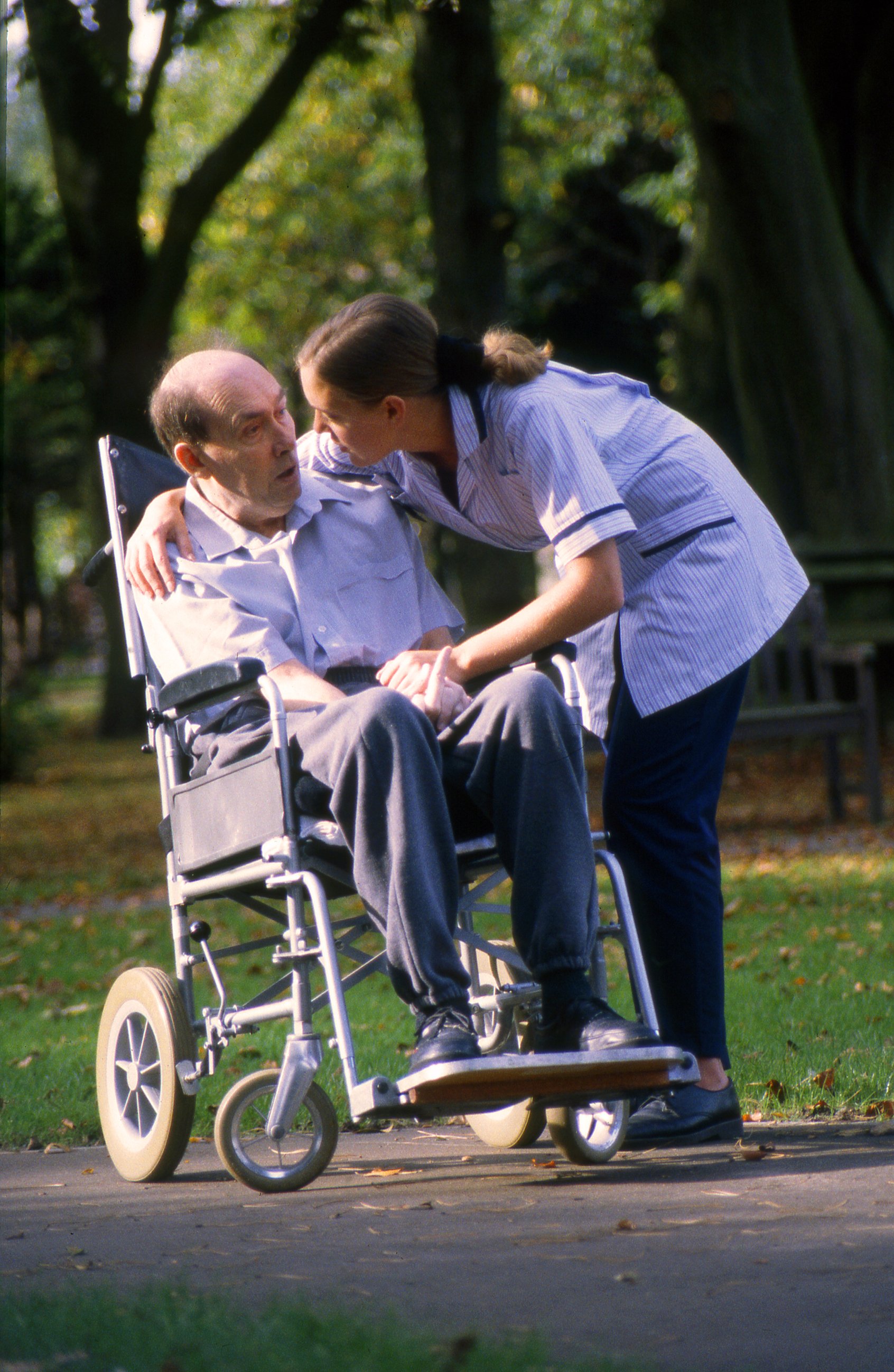Caring Nurse and old man in wheelchair.jpg