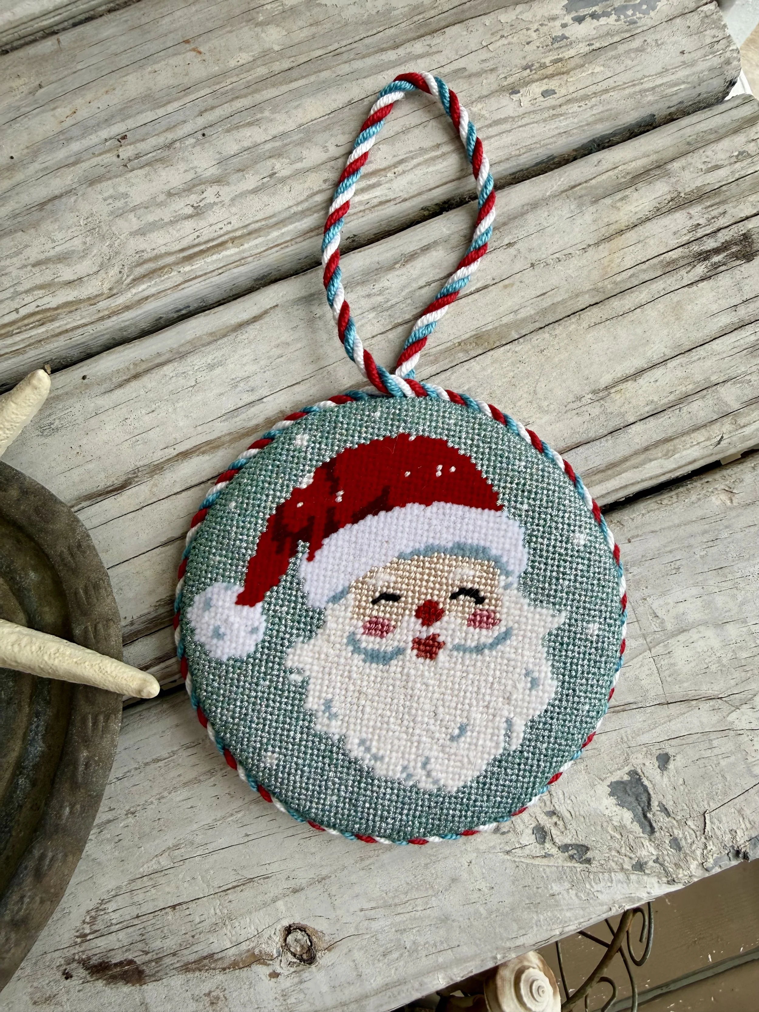 Round Finished Needlepoint Ornament with custom cording. Vintage Santa image hand stitched Finished with The Salty Stitchery