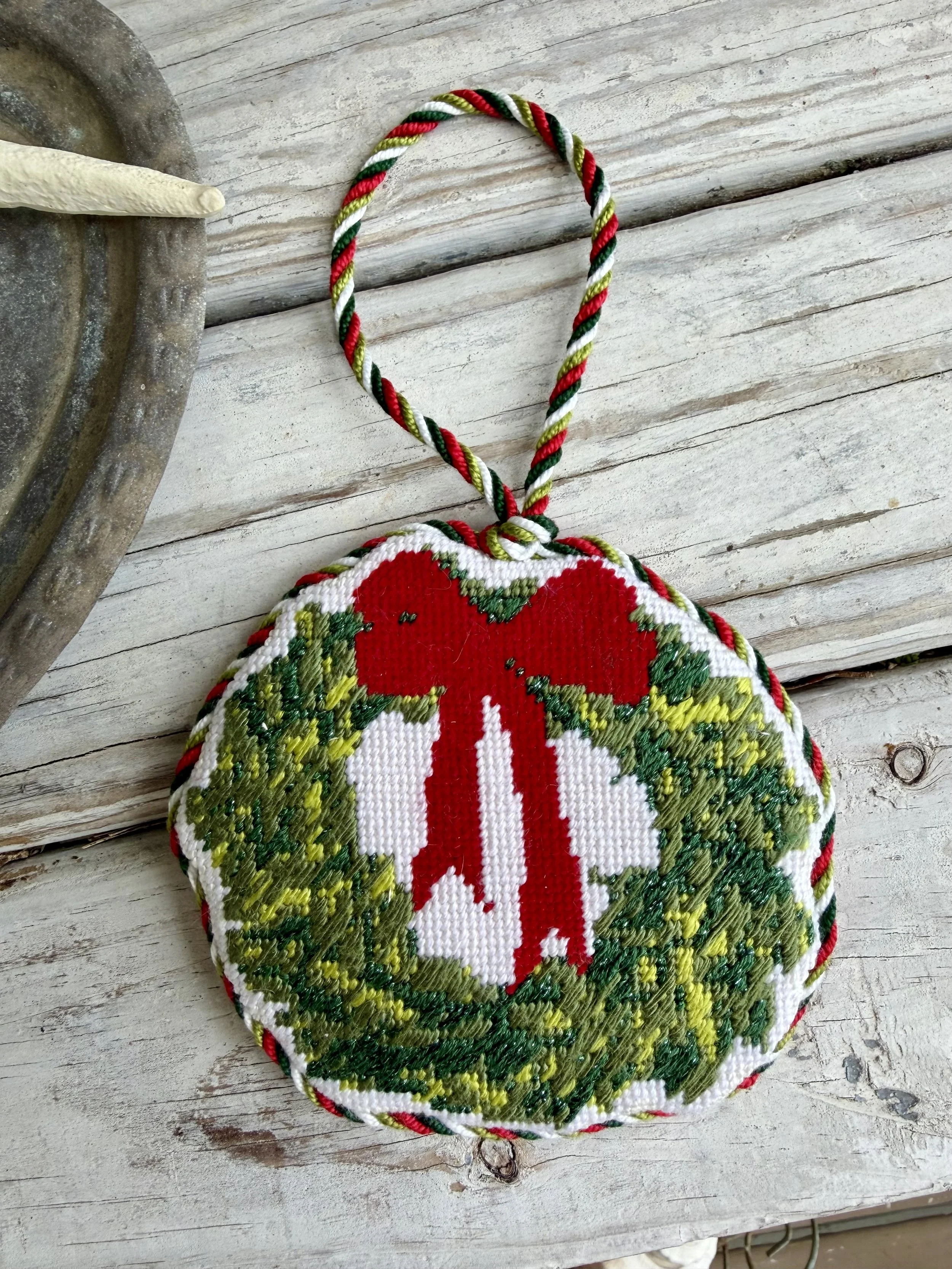 Irregular shaped Needlepoint Ornament of a wreath. Custom cording finished with The Salty Stitchery