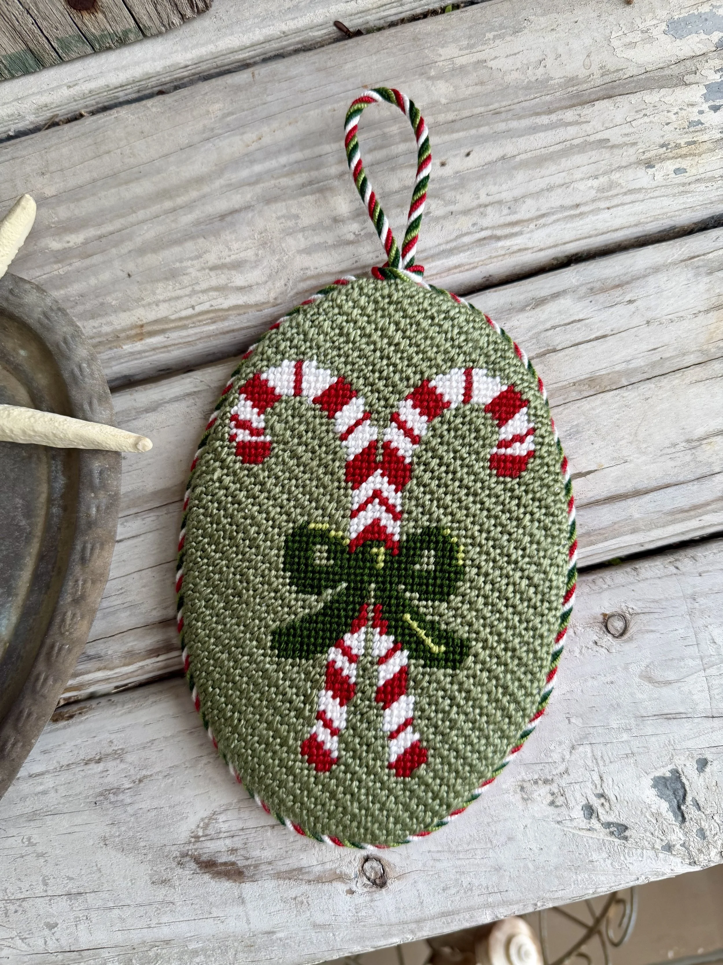 Oval Needlepoint Christmas Ornament with custom cording - Finished by The Salty Stitchery