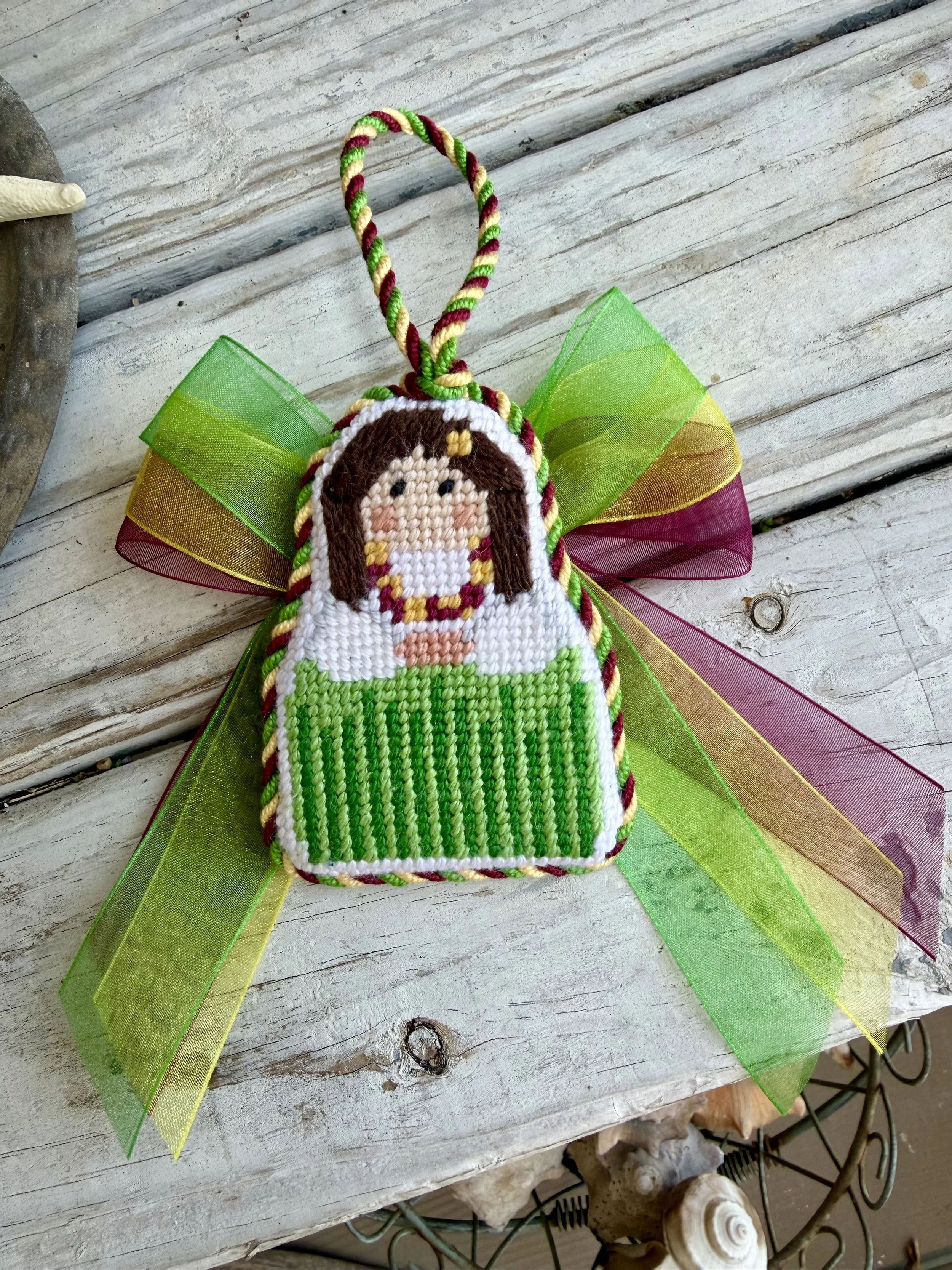 Stitch It Hawaiian Girl Finished Needlepoint Ornament with custom cording. Lowcountry image hand stitched Finished with The Salty Stitchery