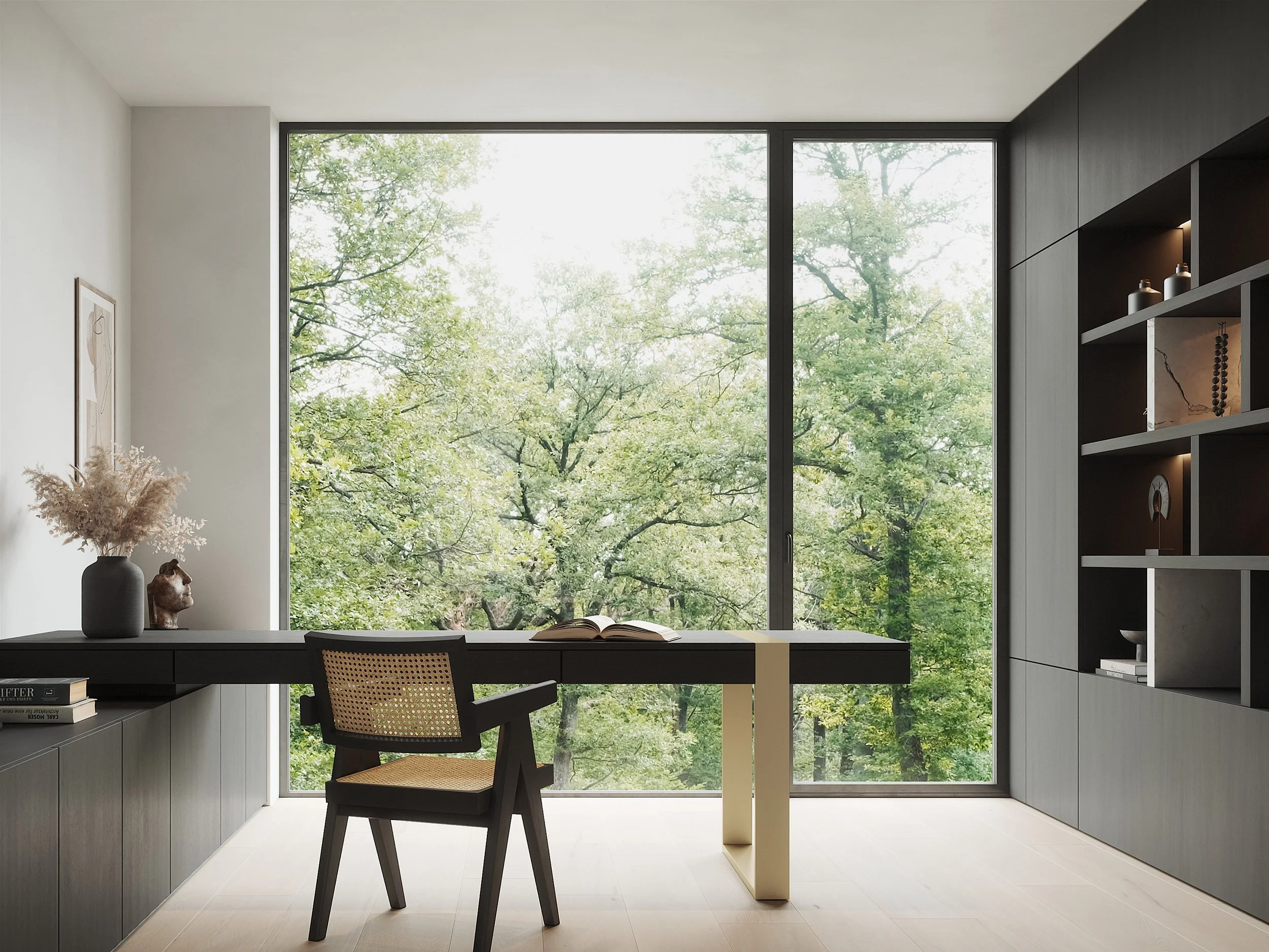 Modern home office with large window overlooking green trees, black desk, chair, and built-in shelving with decor.