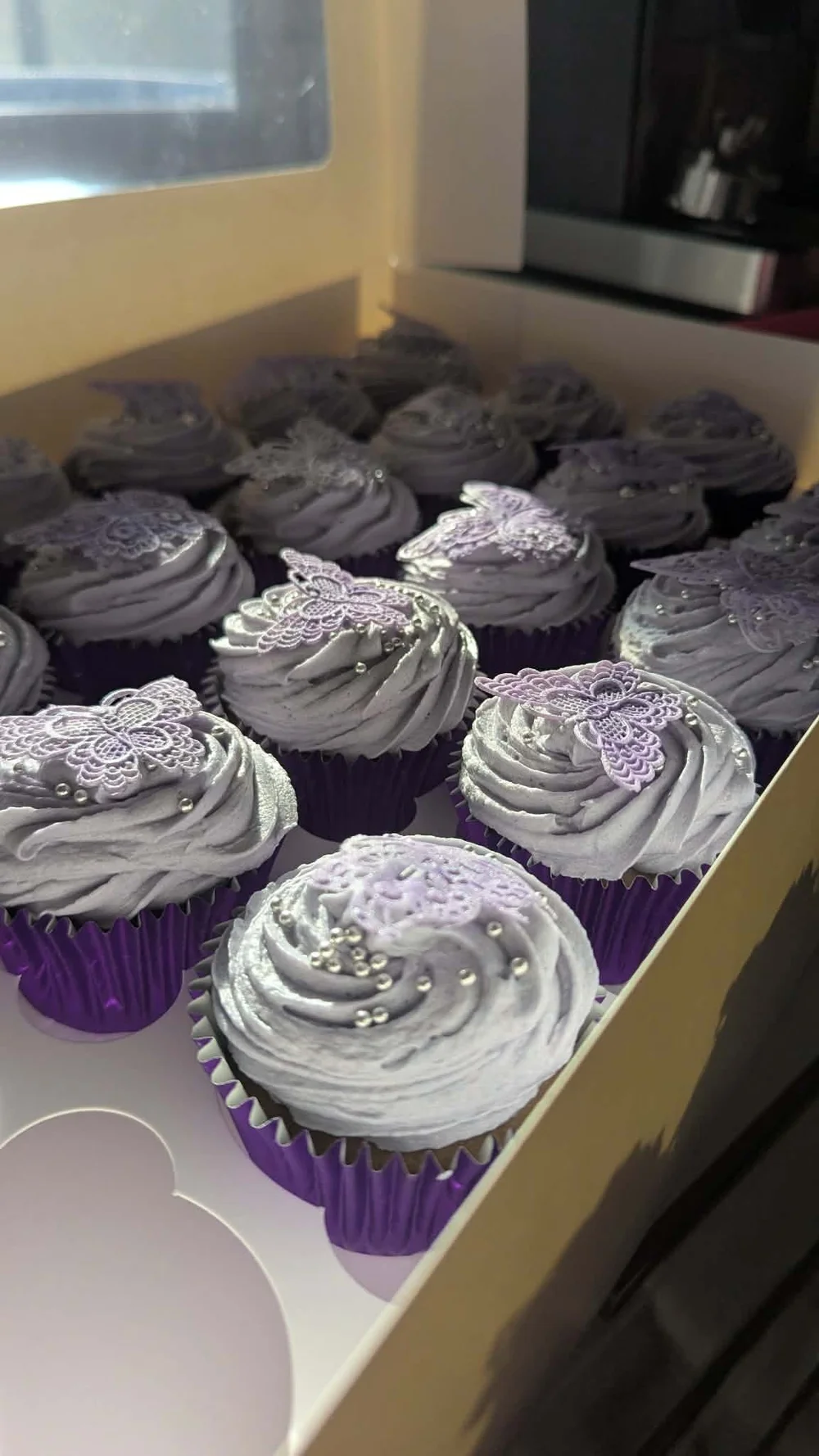 Lactose-free velvet cupcakes with lilac buttercream swirls and edible butterflies