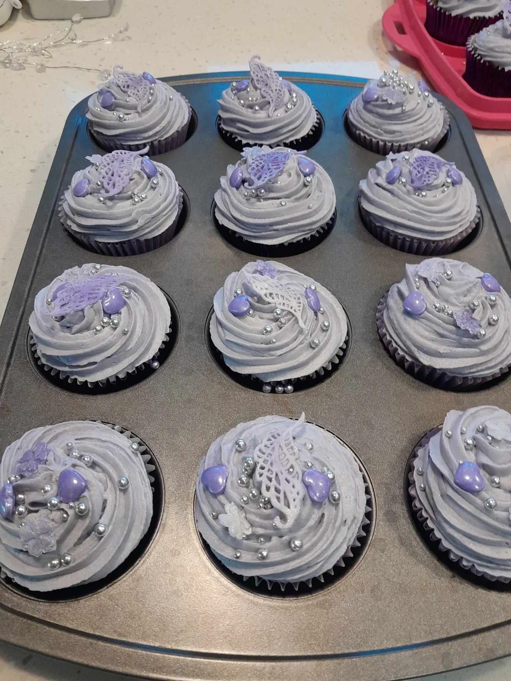 A tray of piped lilac velvet cupcakes