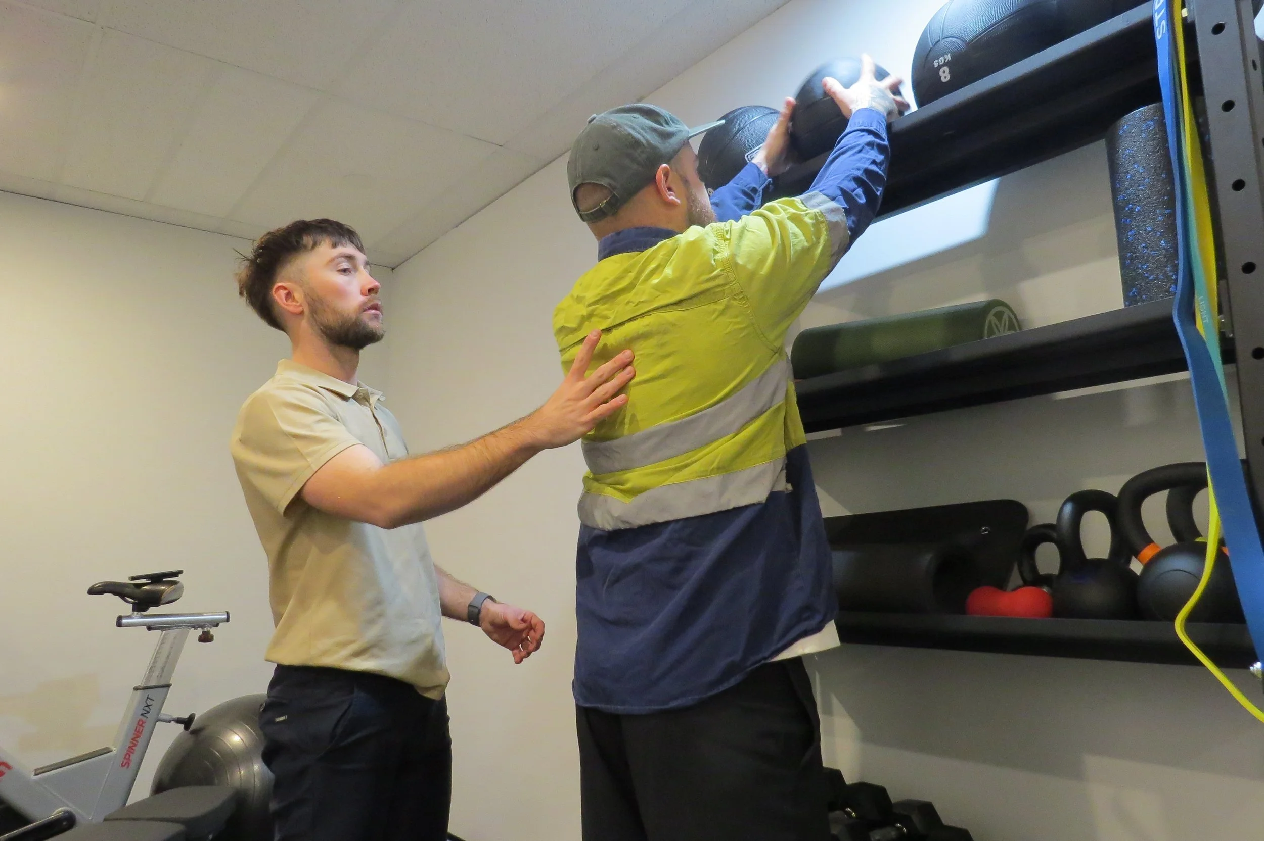 Injured worker lifting a item and replicating their job role