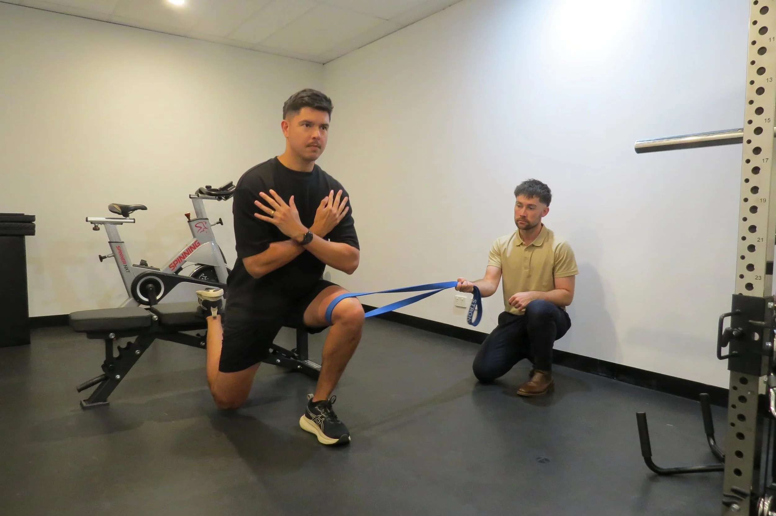 Exercise physiologist assessing a private health patient to help them recover from their injury