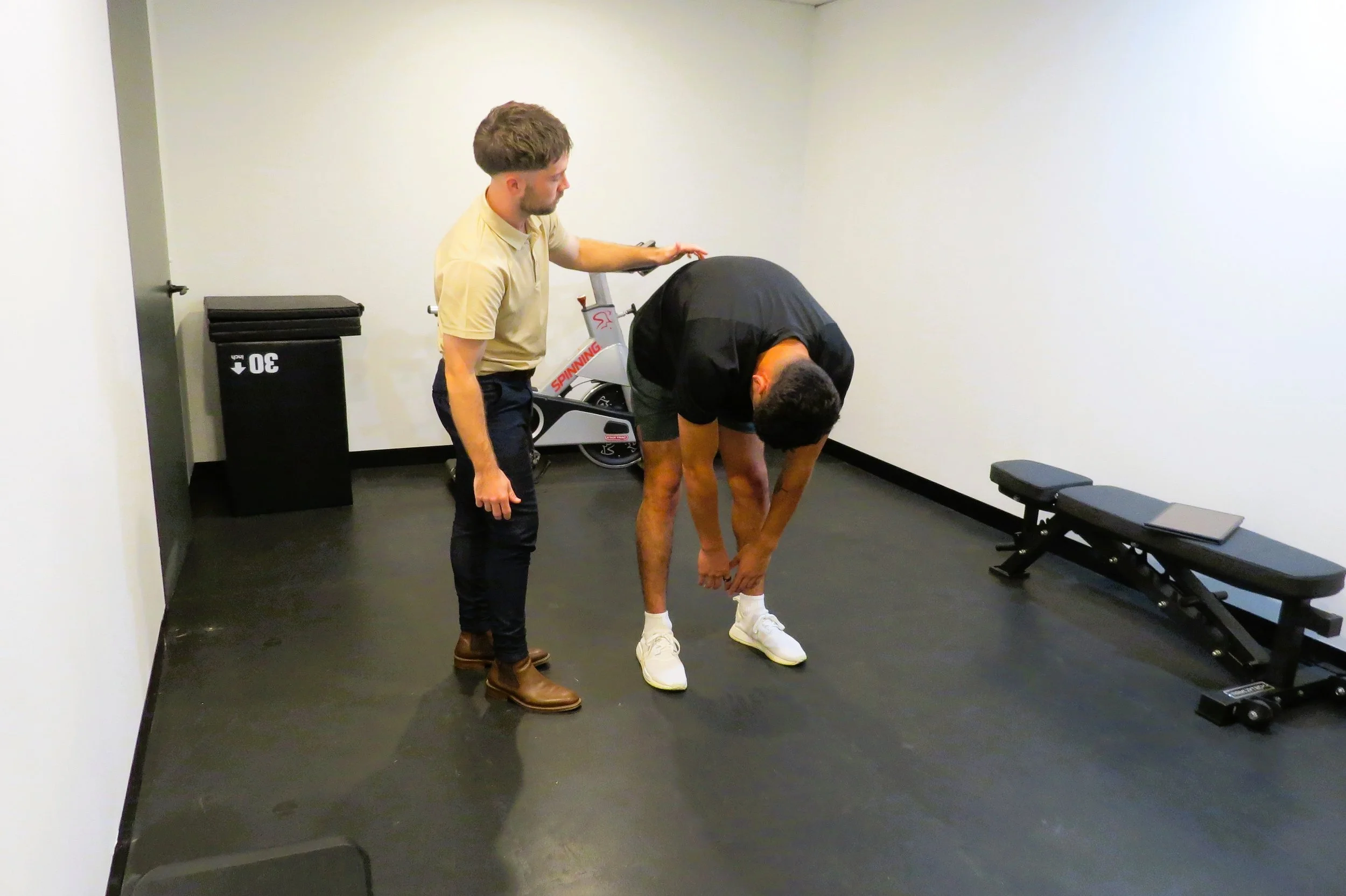 Exercise physiologist doing a lower back assessment