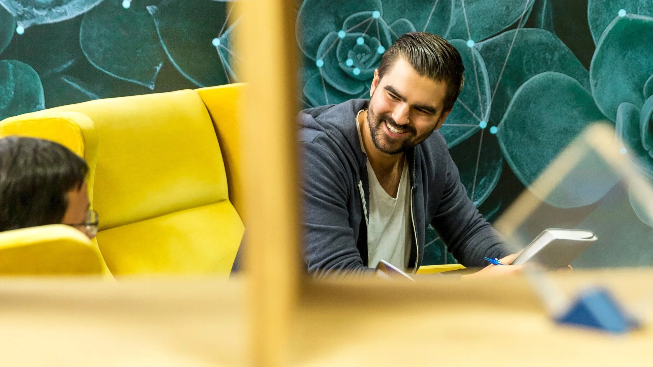 Man smiles a colleague