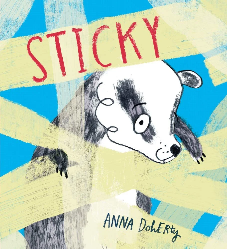 Book cover for "Sticky" by Anna DoheRty featuring a drawing badger with black and white fur looking through yellow sticky tape on a blue background.