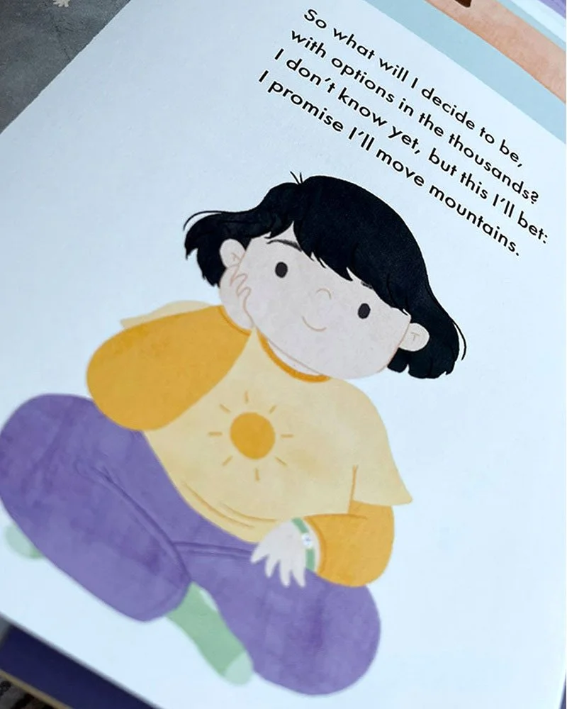 Illustration of a young girl with black hair, sitting cross-legged, wearing a yellow shirt with a sun symbol and purple pants, smiling and looking forward.