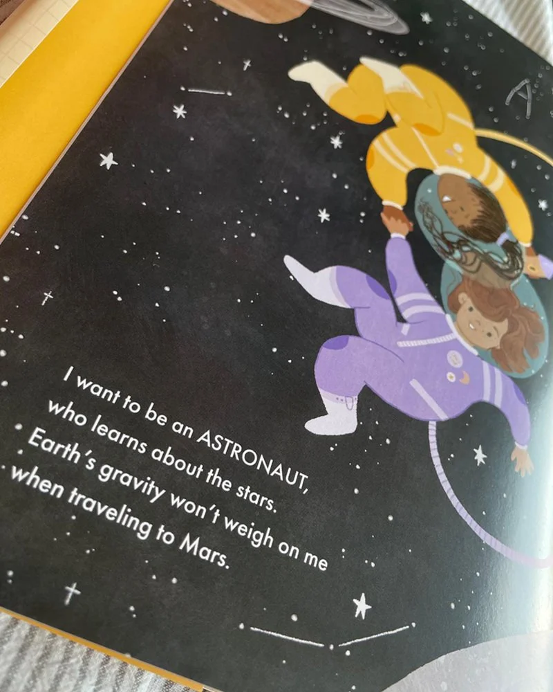 Illustration of two children floating in space with stars, one dressed as an astronaut and the other in casual clothing, against a black starry background.