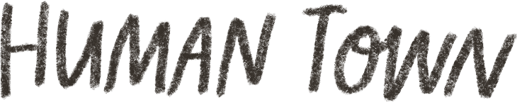 Text reading 'HUMAN TOWN' in black font on a white background.