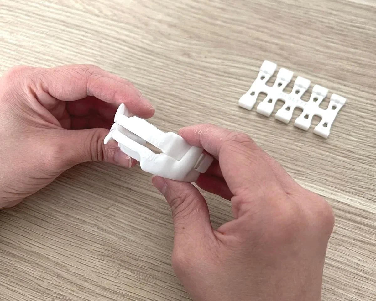 a SleepWise 3D printed medical grade nylon mandibular advancement anti-snoring dental splint with the adjusters to allow the lower jaw to move forward bit by bit