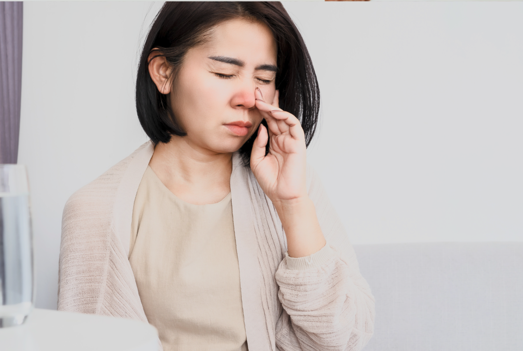 lady with a red blocked nose and a sinus discomfort