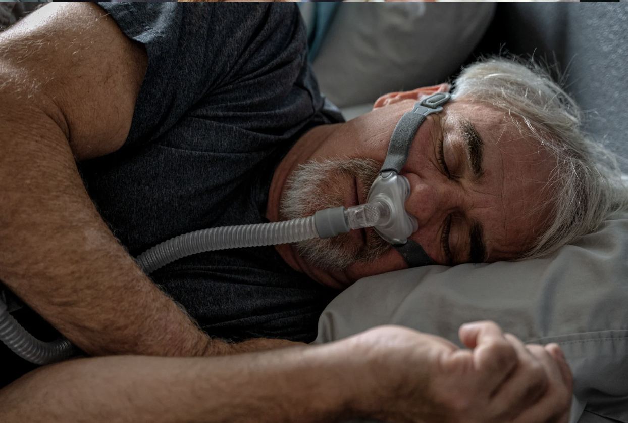 man sleeping with CPAP machine comfortably