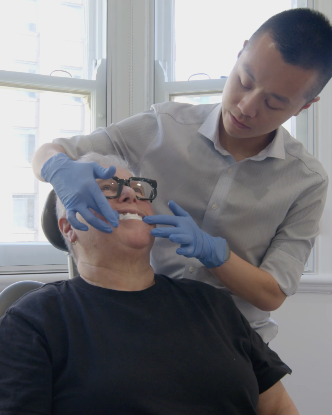 Sleep medicine dentist fitting a mandibular advancement splint for a patient onto their teeth