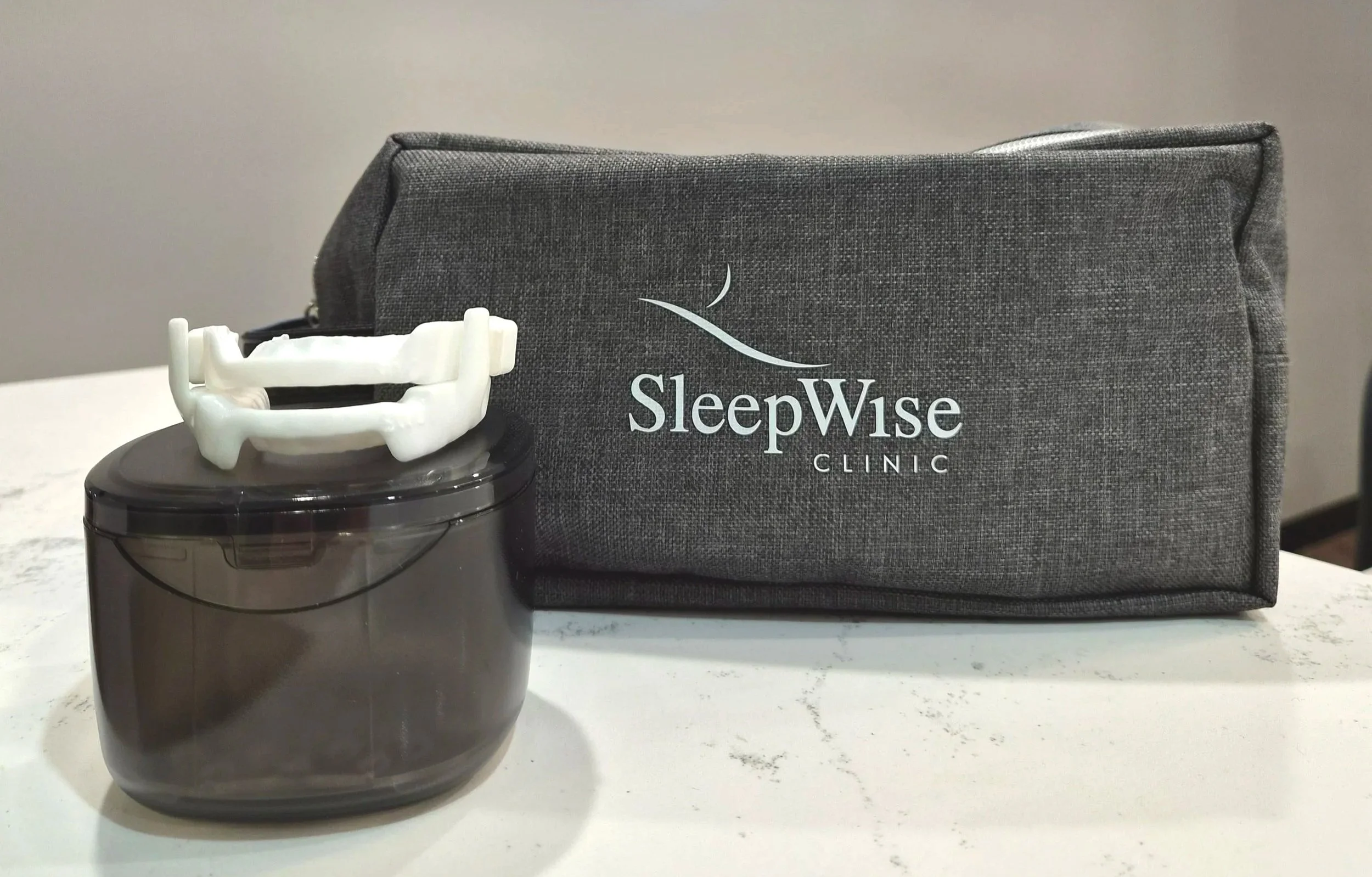 a sleepwise snoring oral device and cleaning container free for patients along with a grey mandibular advancement splint care bag containing an appliance toothbrush, denture cleaning tablets appliance cleaning tablets and instructions for use