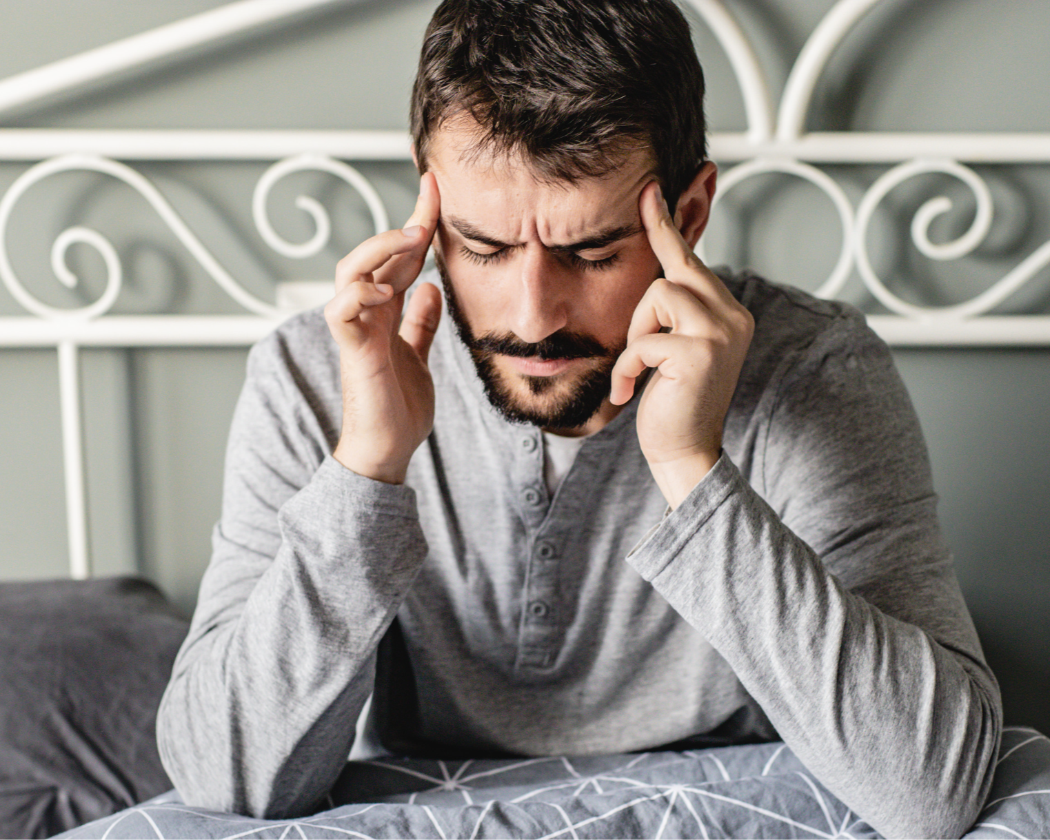 man with a sore jaw from grinding his teeth the whole night needing an oral appliance splint which will act as a night guard to support his jaw and airway