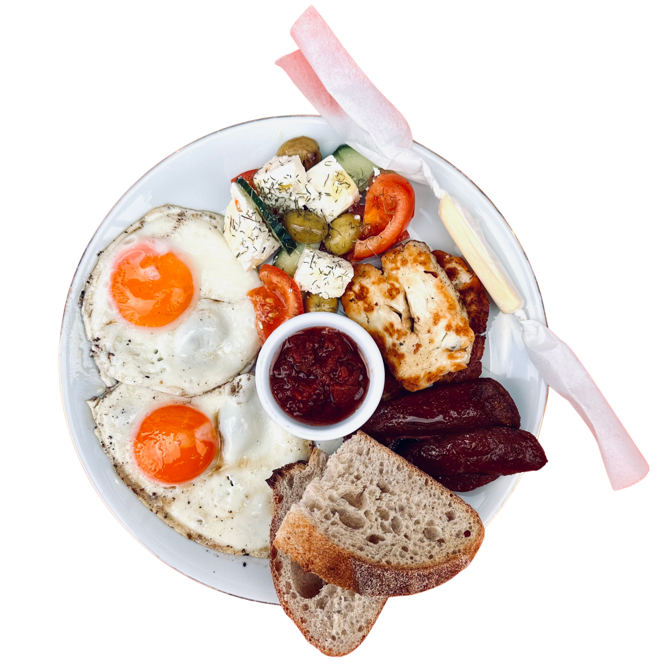 Plate of breakfast with sunny side up eggs, cherry tomatoes, green olives, cucumber salad, toast, and syrup.